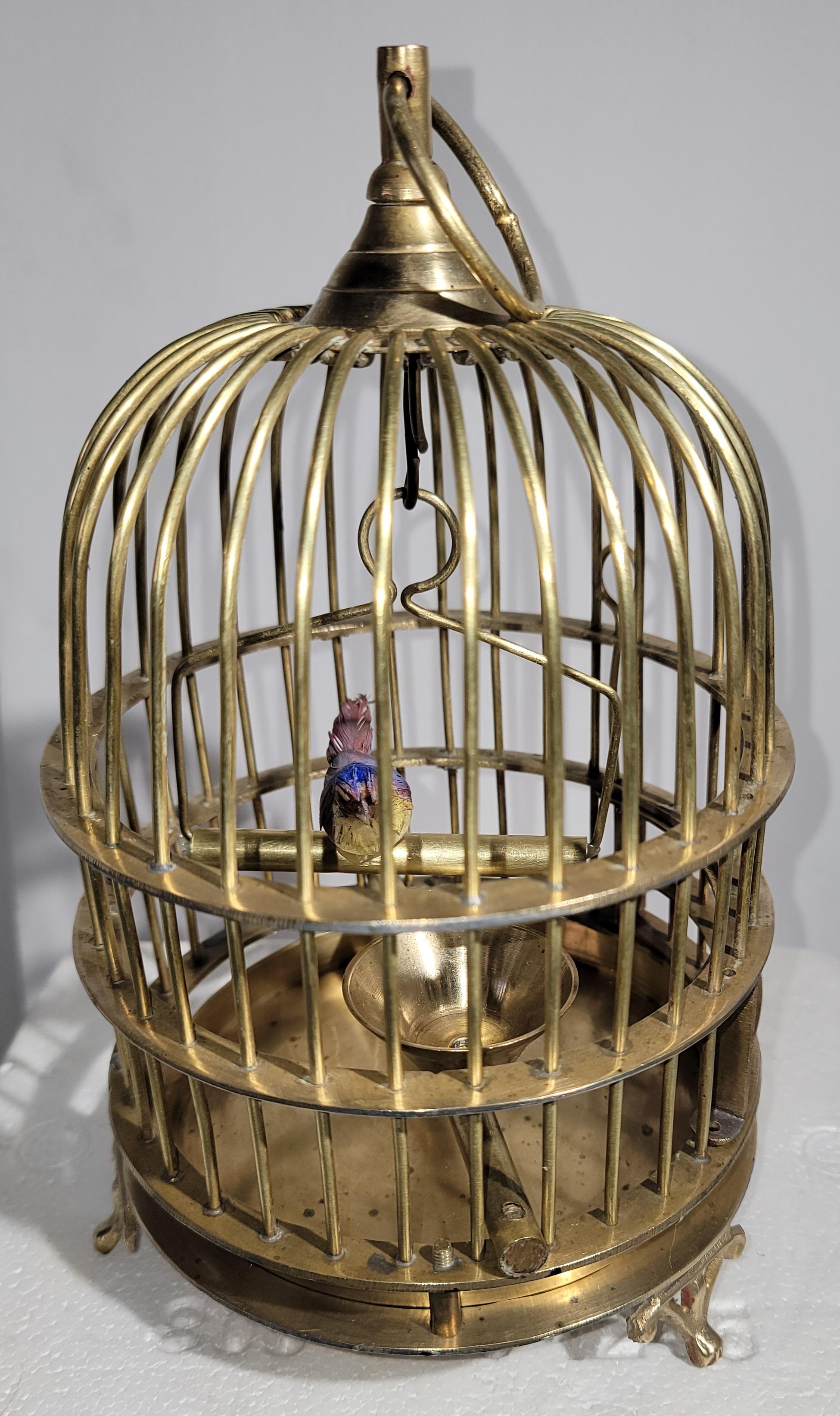 This mini brass bird cage has a bird inside and really could be used for a tiny bird.The condition is very good and it has been polished.