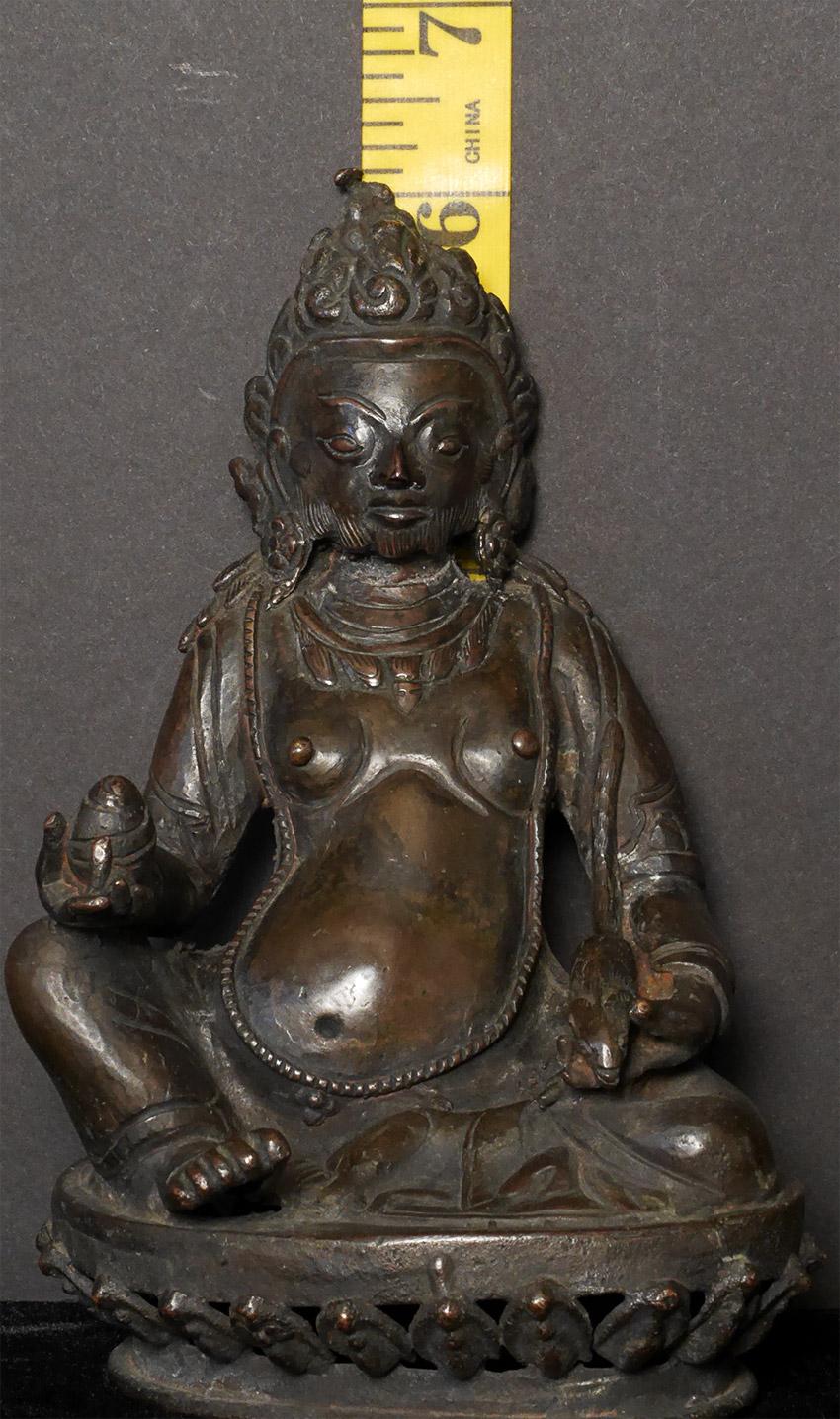 This is a delightful sculpture of Jambahala. It is from Nepal, early 20th century. You see numerous Ron's Buddhas and bodhisattvas and Tara statues from this period. Jambahala however, is rarely sculpted in Nepal. virtually all of the sculptures
