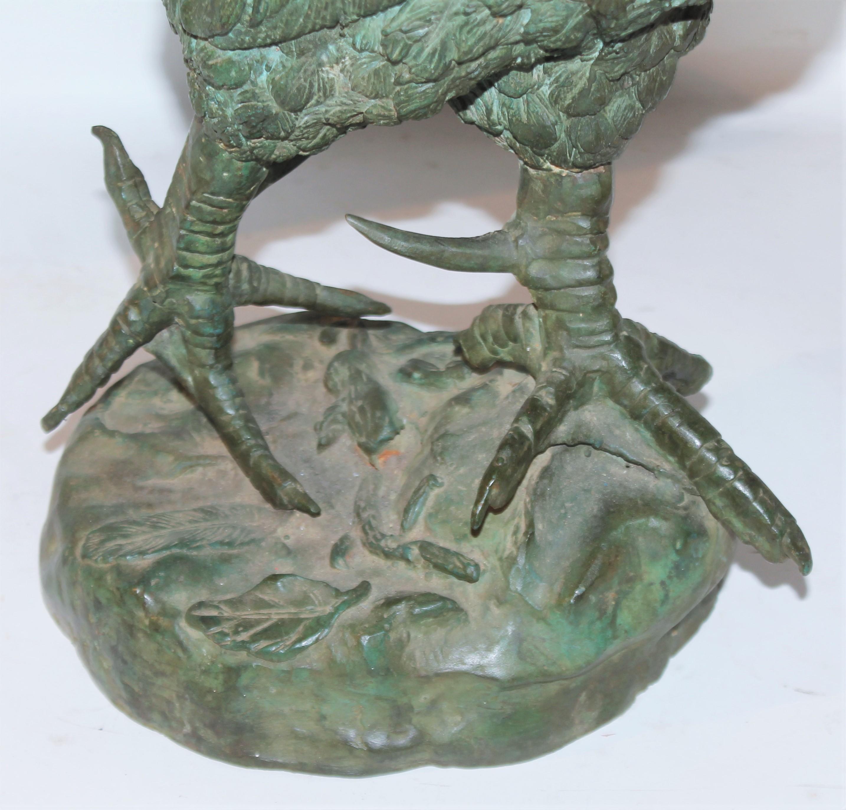 Early 20thc large rooster bronze sculpture in amazing undisturbed surface. This fine piece of art has a wonderful patina. Minor piece missing off a feather & does not detract from the sculpture.