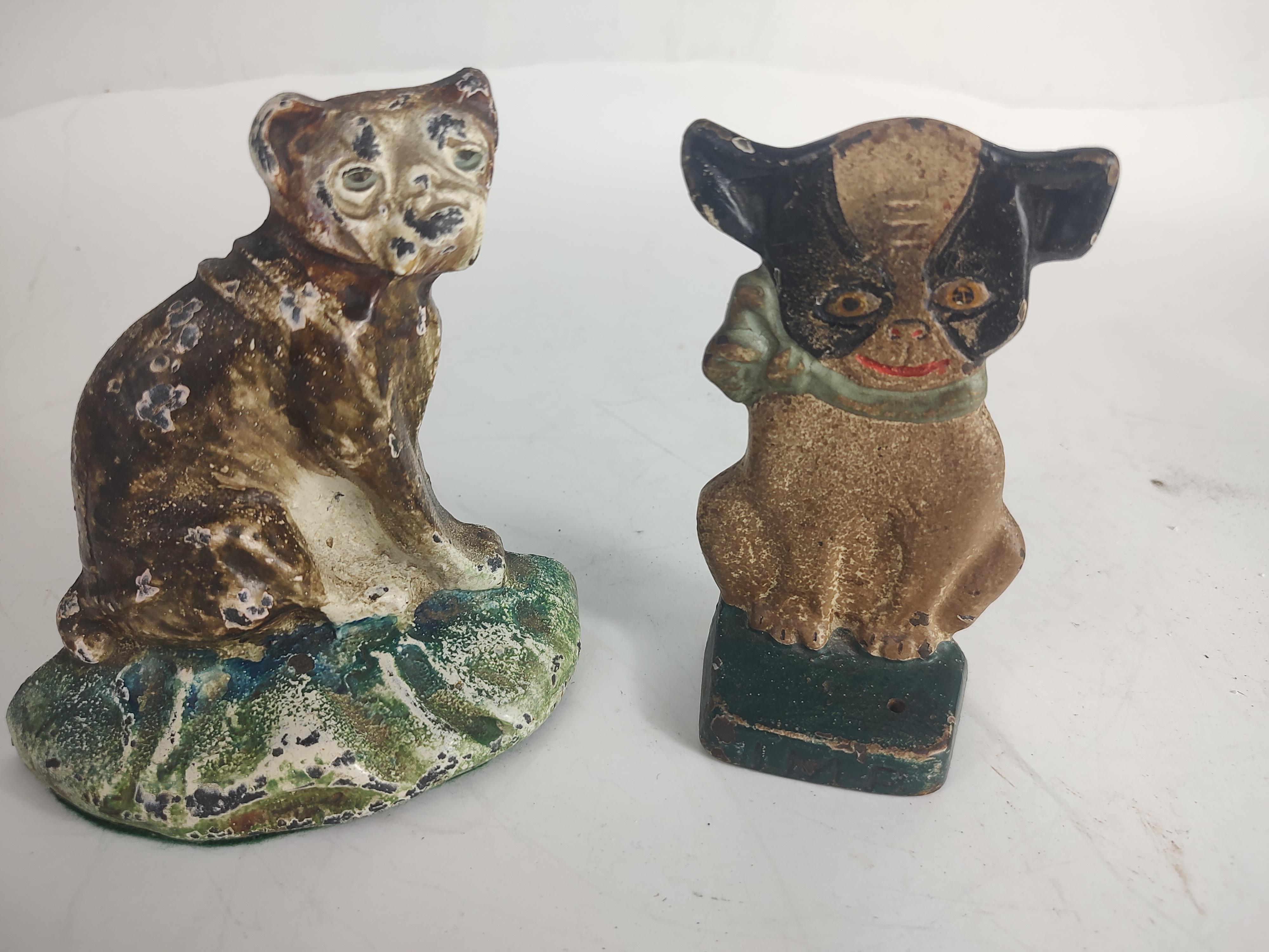 Two fabulous cast iron dog doorstops in original paint. A boxer and the other not sure of the breed but it's named Imp and cast below the feet. Boxer Size is 5w x 5.5h x 1.75d Imp is 5.25hx 3.25w x 1.75d Crisp castings. Sold as a set of 2. Imp is