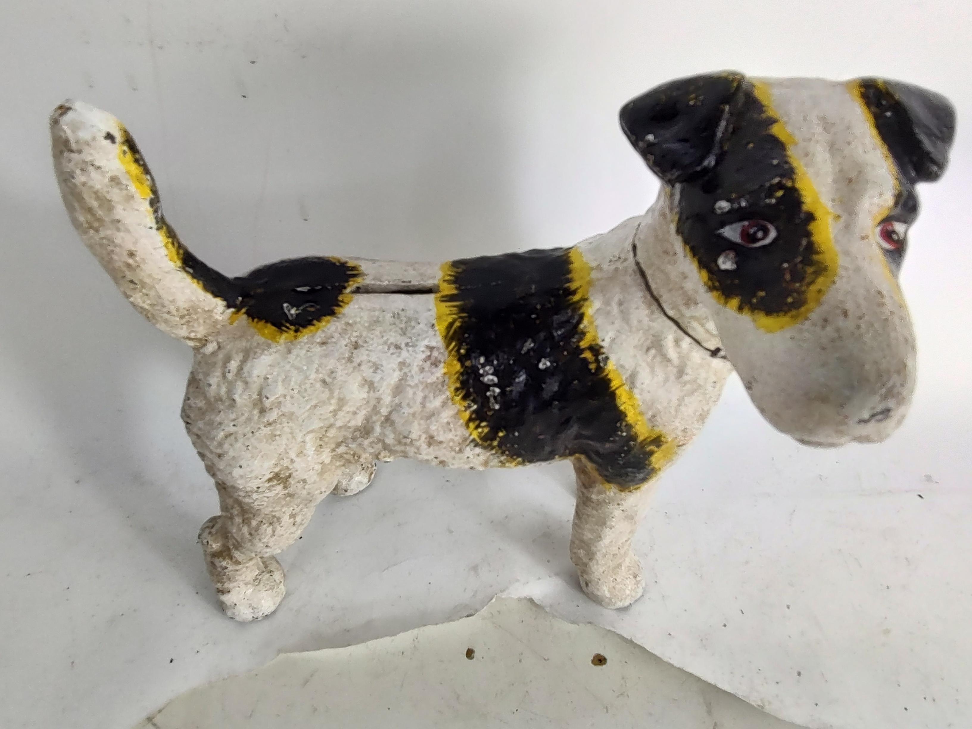 Fabulous hand painted cast iron Jack Russell Terrier by Hubley in original paint. In excellent antique condition with minimal wear. Has a slot for coins on top so it doubles as a bank.