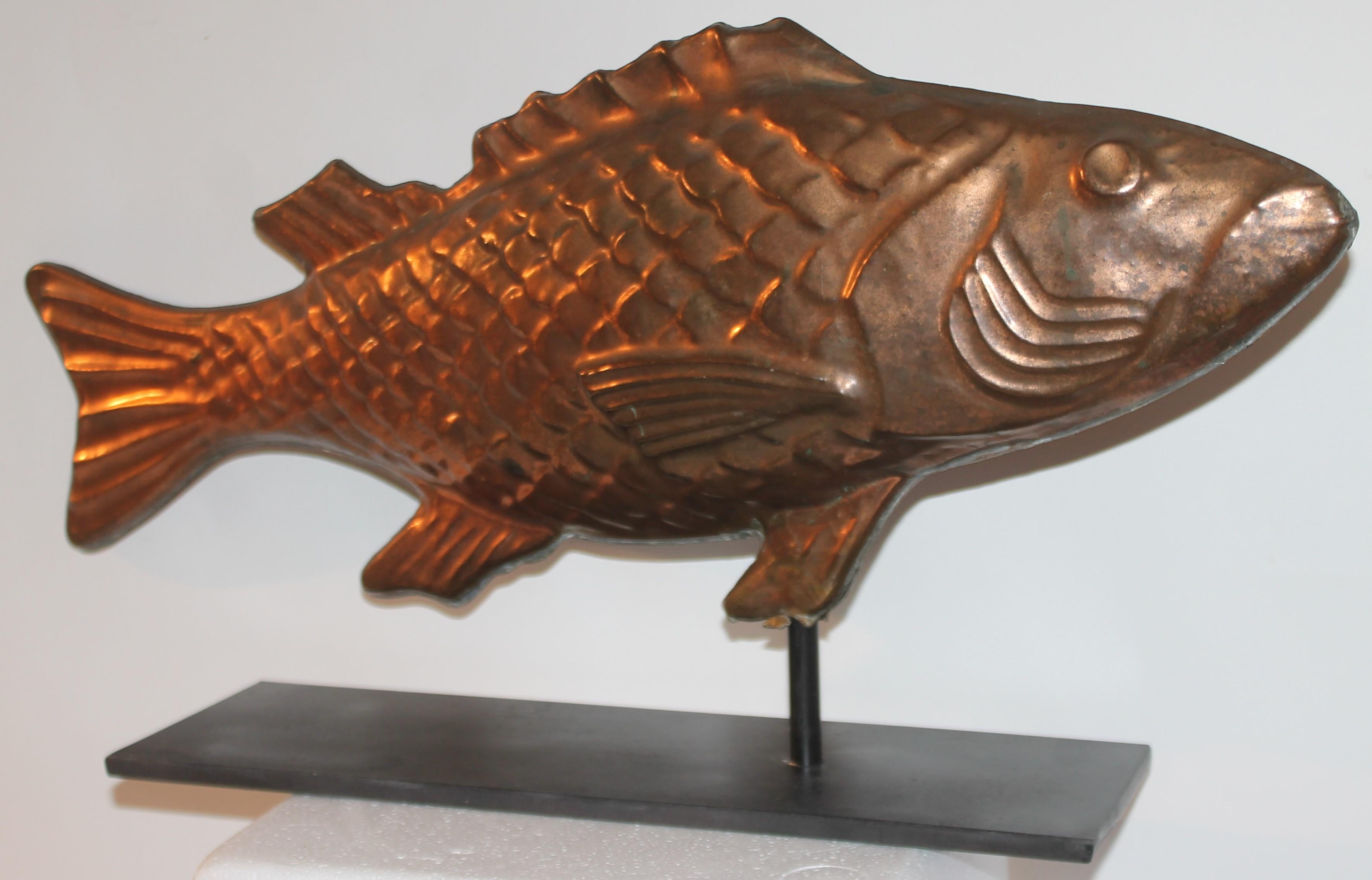 Early 20thc full bodied copper professionally polished fish weather vane with custom made iron base.