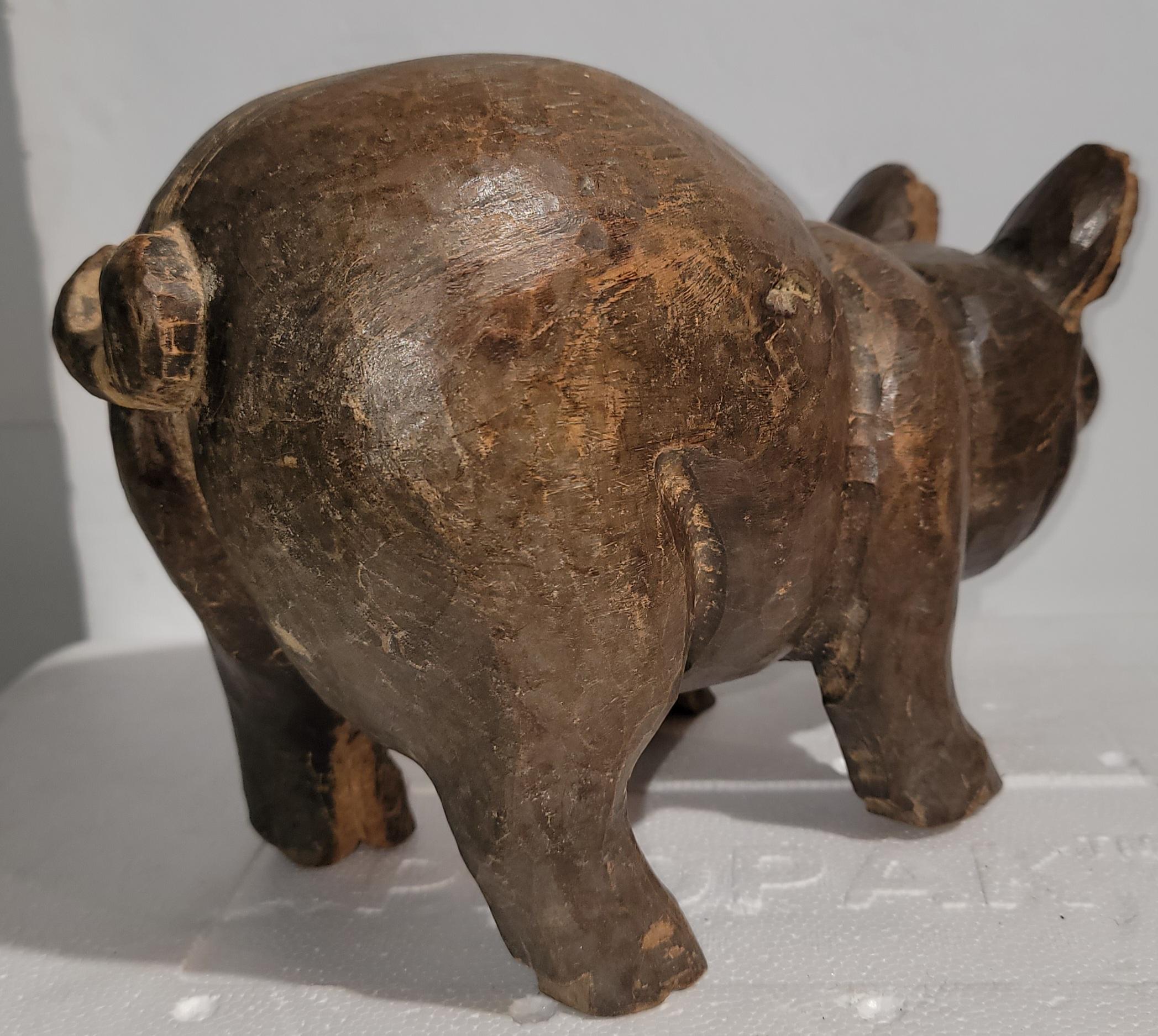 Early 20thc hand carved pig or hog with amazing patina. This is most unusual and found in the mid west.
