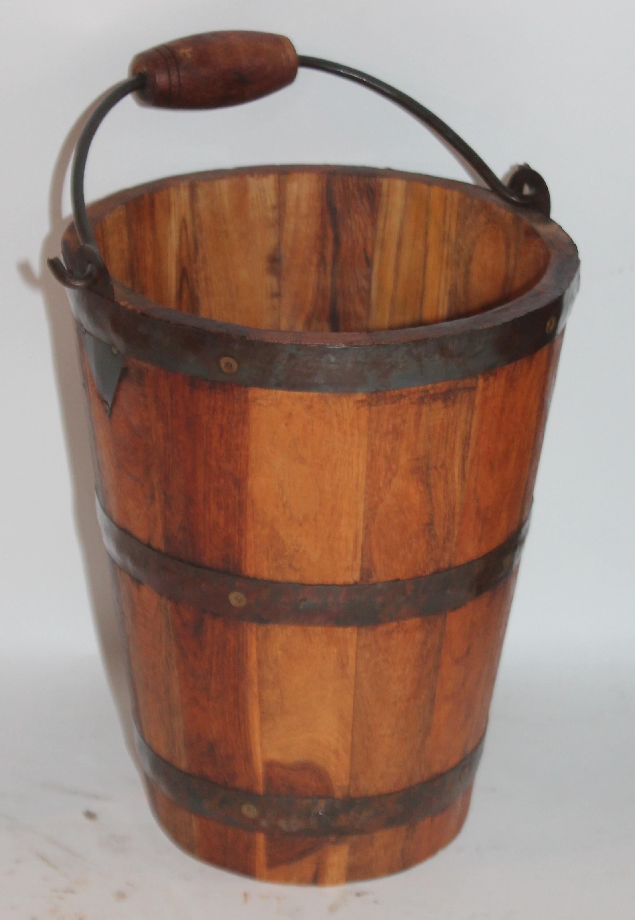 This fine early handcrafted bucket has handcut tin trim and hand forged iron. It retains the original handle.