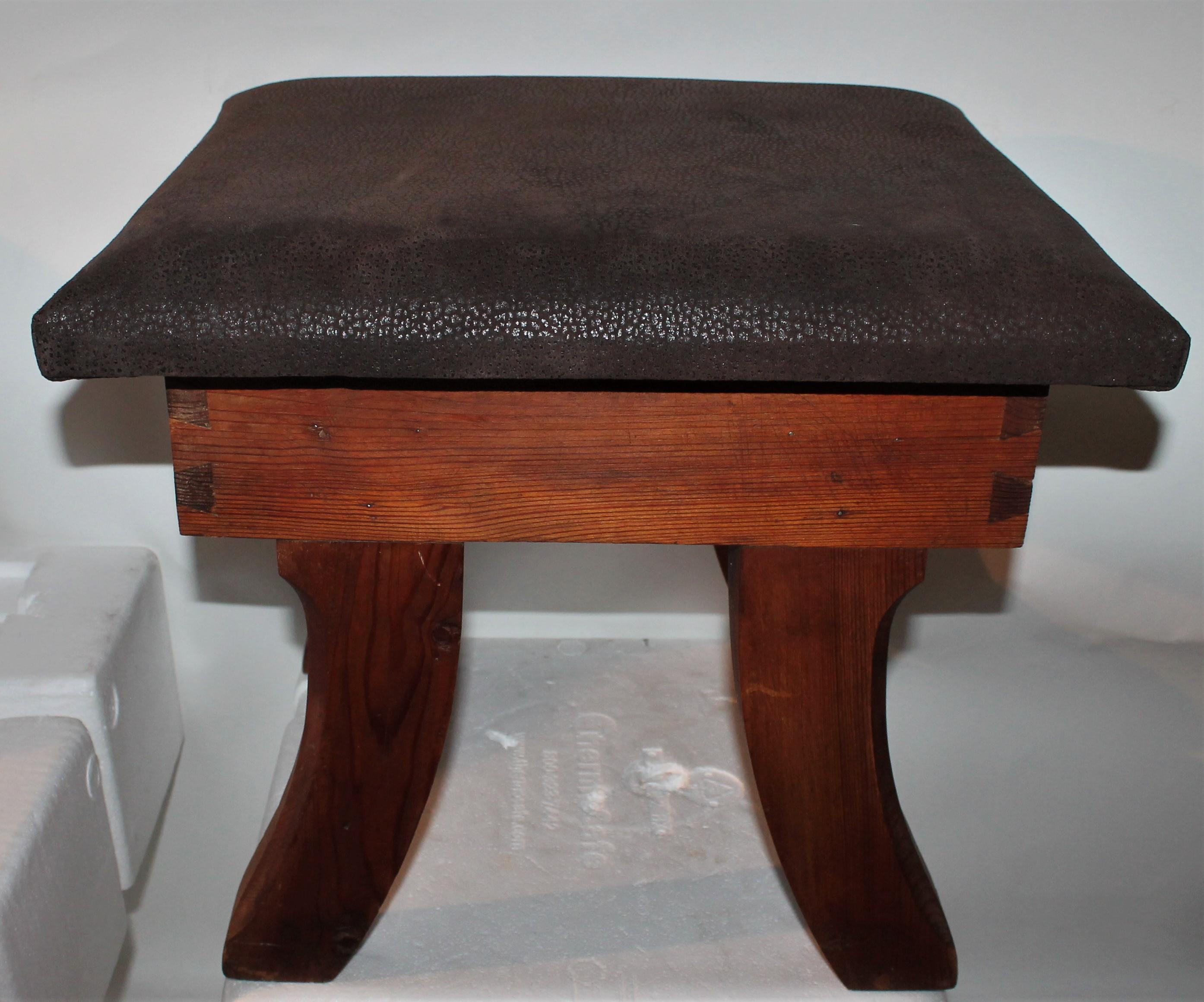 This early dovetailed walnut stool is covered in leather and in very good, sturdy condition. Was found in New England.