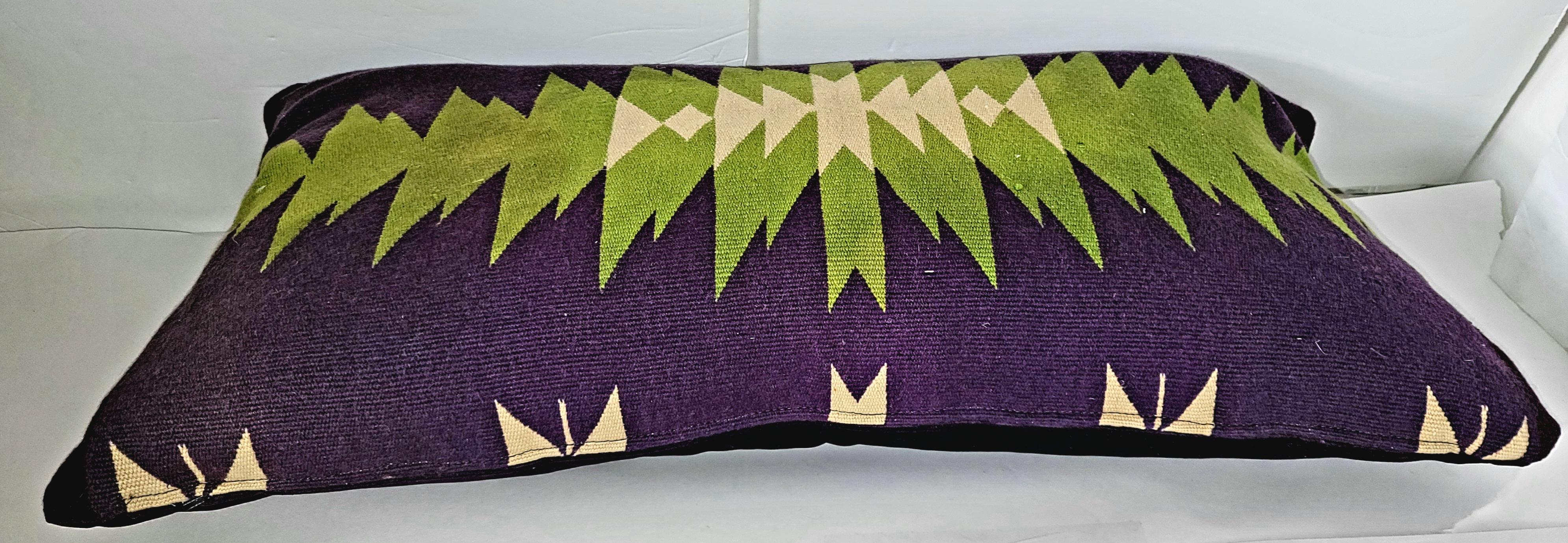 Early 20thc Navajo Indian weaving bolster pillow in purple & vibrant green wool and purple velvet backing. The insert is down & feather filled.