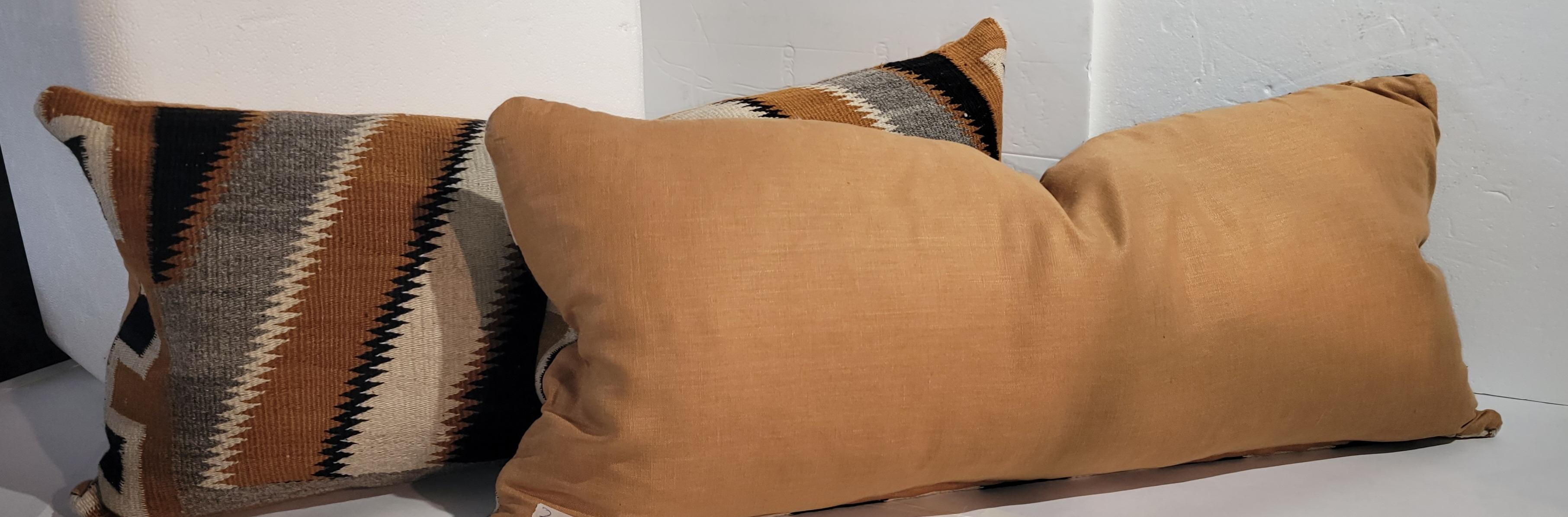 Amazing Navajo Indian Weaving Saddle blanket pillows from Santafe in pristine condition. The backings are in cotton linen. The inserts are down & feathered fill.Sold as a pair.