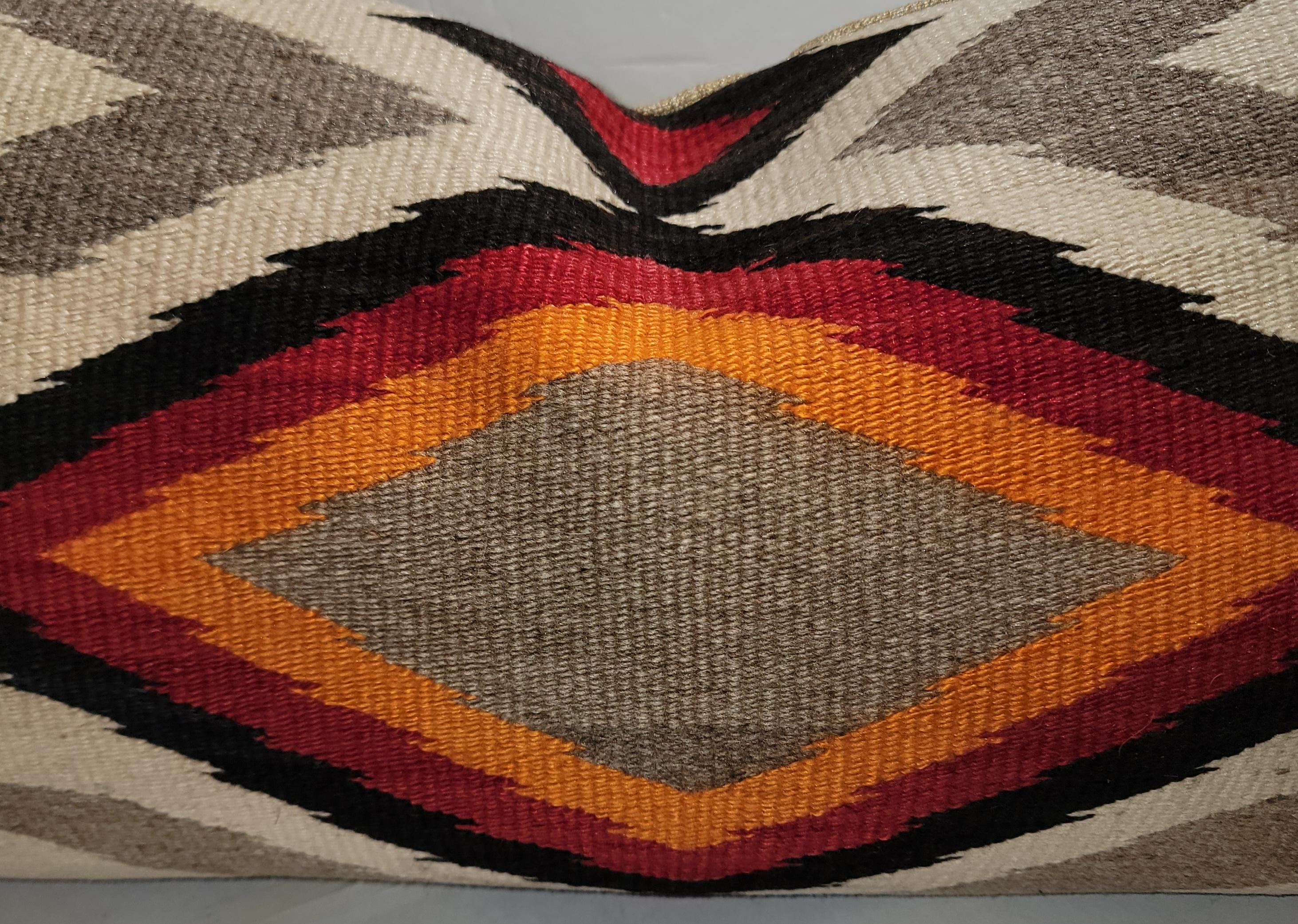 Geometric Navajo weaving pillow in vivid colors and a linen backing. The insert is down & feather fill.