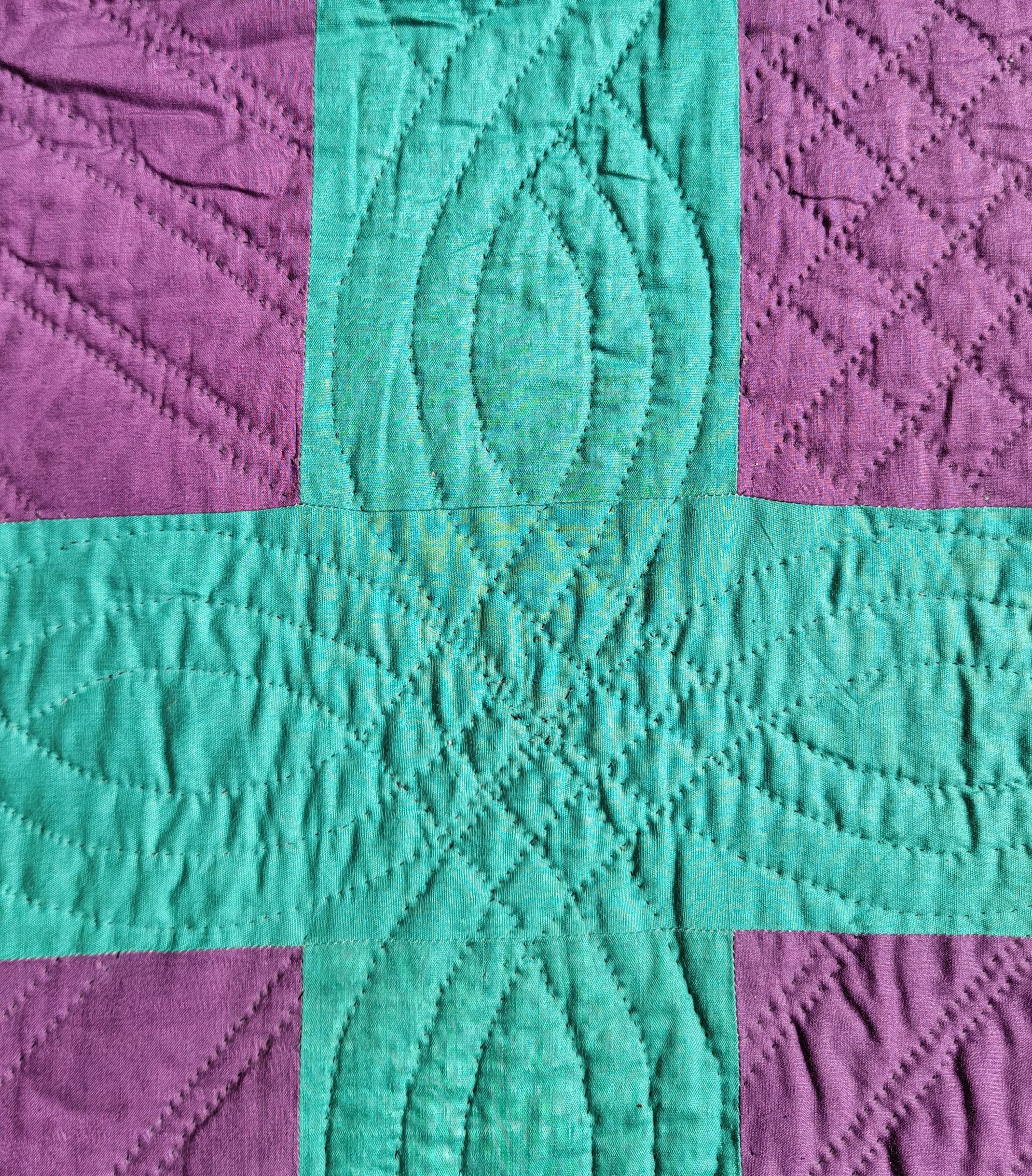 This fine quilted Ohio Amish plain quilt is in a purple cotton and inner mint green borders.The quilting is very fine and the quilt is in pristine condition. Super rare colors and a fine example of early Amish highly quilted plain quilt. Fantastic