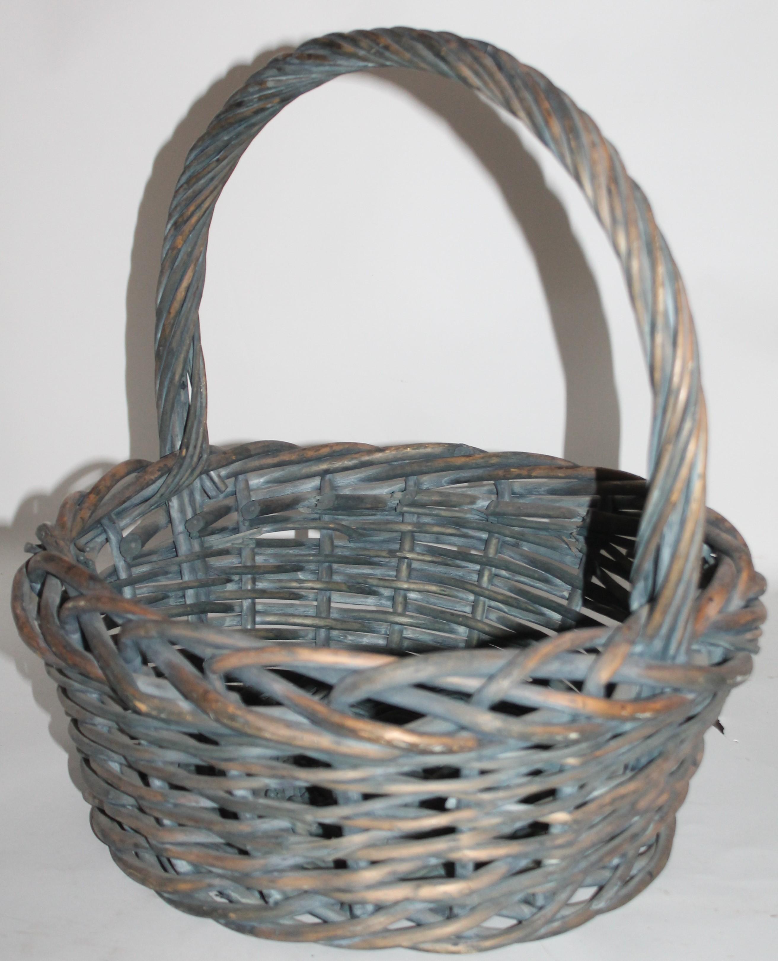Early 20th century original blue painted handled basket in good condition. Found in the mid west.