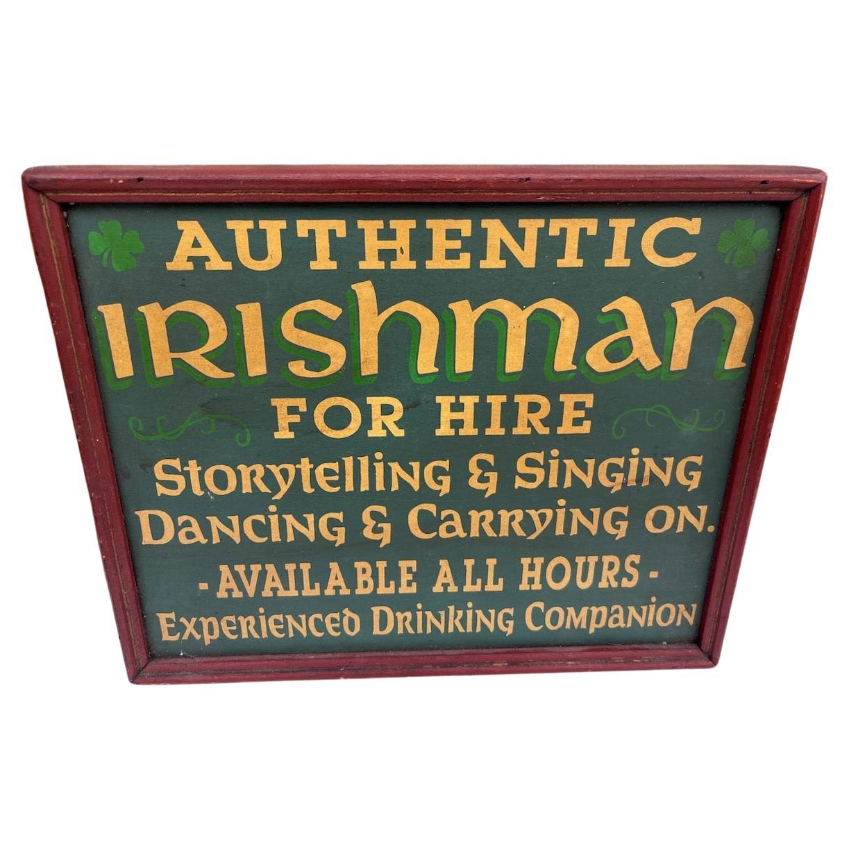 This fun trade sign is comical and yet very cool.It is all in original painted surface and amazing picture frame molding in red paint.Ready to hang in your home or man cave. It reads :
 AUTHENTIC IRISHMAN -FOR HIRE ; 
STORYTELLING & SINGING ,