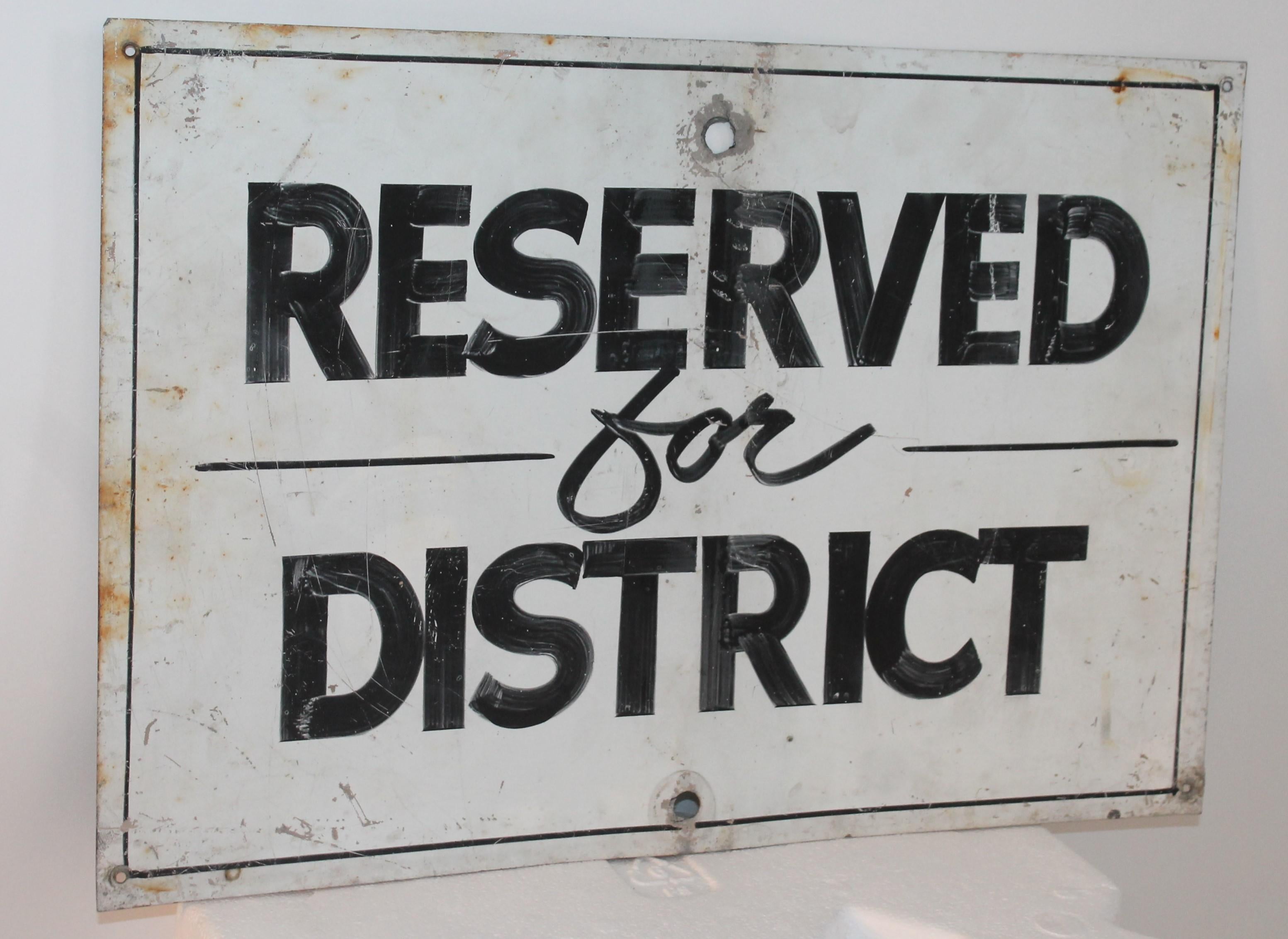 This original painted black and white trade sign reads Reserved for district. This cool one sided sign was probably from a old vintage court house.