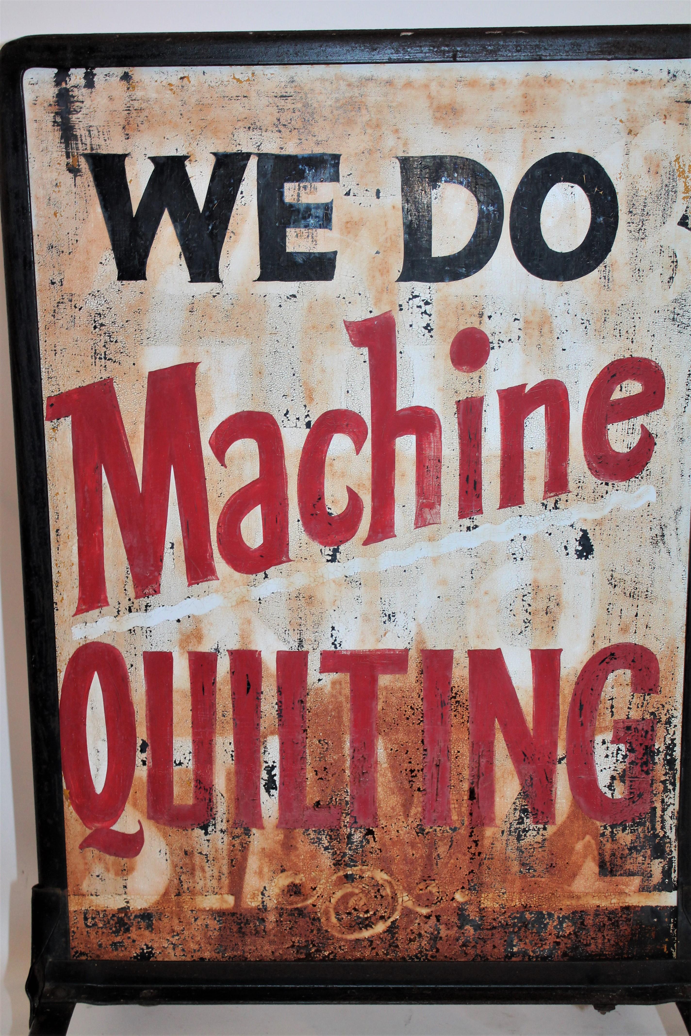 This double sided sheet metal with iron frame sandwich board reads : WE DO MACHINE QUILTING and it is on both sides. This is a all original painted double sided street or window sign.
