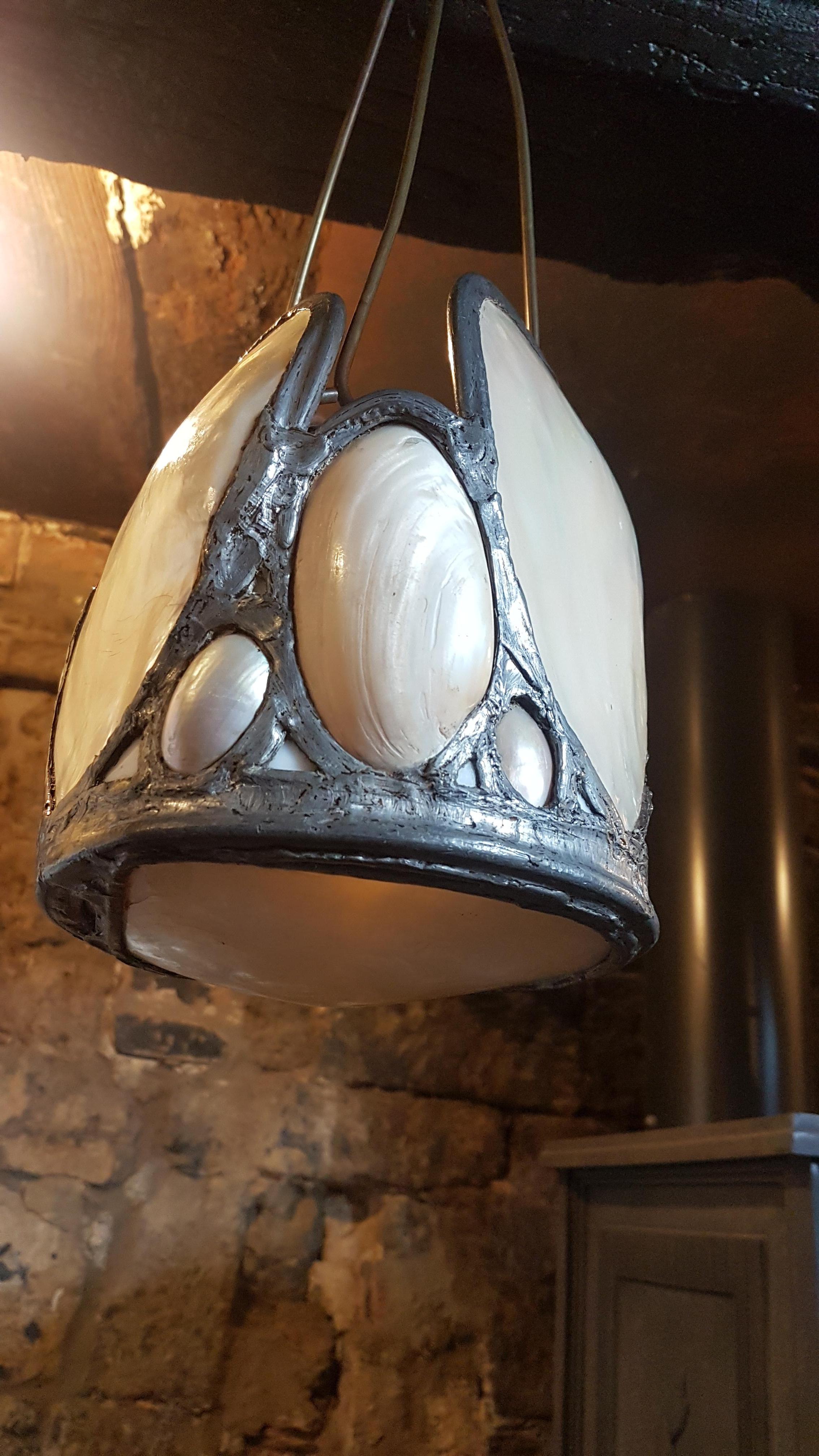 A superbly decorative and elegant custom made lantern that is constructed from large oyster shells that have a great opalescence to them when the light is on the inside with these being set in lead. The shells are all in excellent condition, the