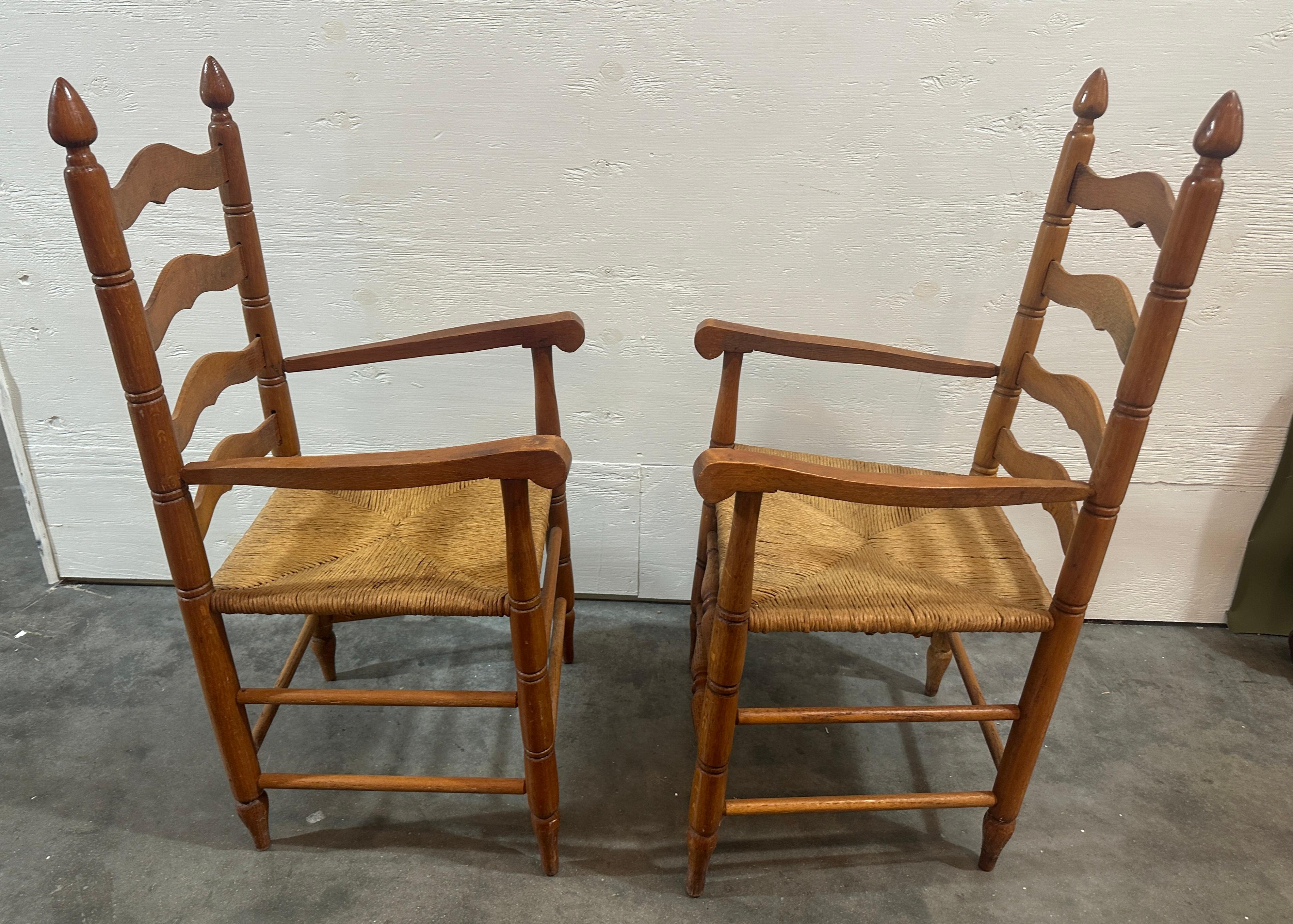 Pair of hand made ladder back chairs with rattan seats. The finial tops add a wonderful look to the entire design.
The rattan seats are wonderful to sit on as the contour to the person sitting. 

Great condition.
