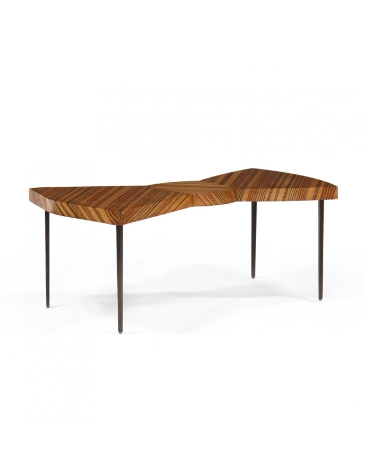 Jonathon Charles Furniture, contemporary, maple with walnut and ebony line inlays to the top and edges, coffee or accent table with bronze tone metal legs, unmarked.

Measures: 47.5 W x 25.75 D x 19.5 H

The table offered here is from a 2012