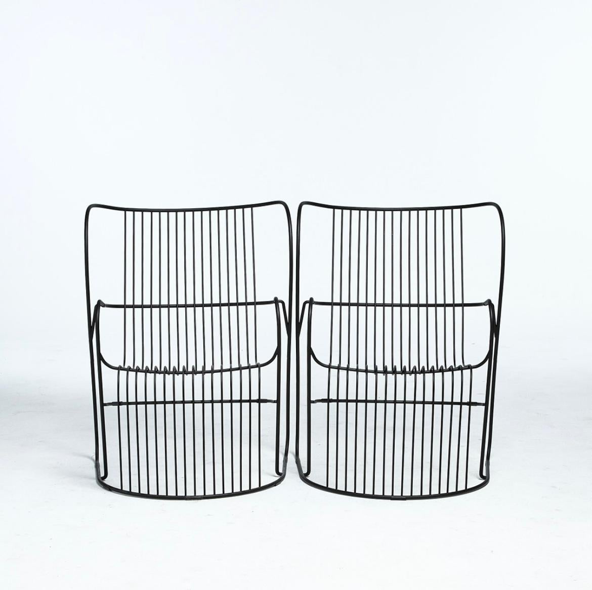 A pair of award-winning Kaskad (Cascade) armchairs by BJÖRN DAHLSTRÖM. A contemporary design crafted from ribbons of curved zinc-electroplated steel attached to a contouring frame. The chair’s fluid form and flowing lines recall shapes commonly seen