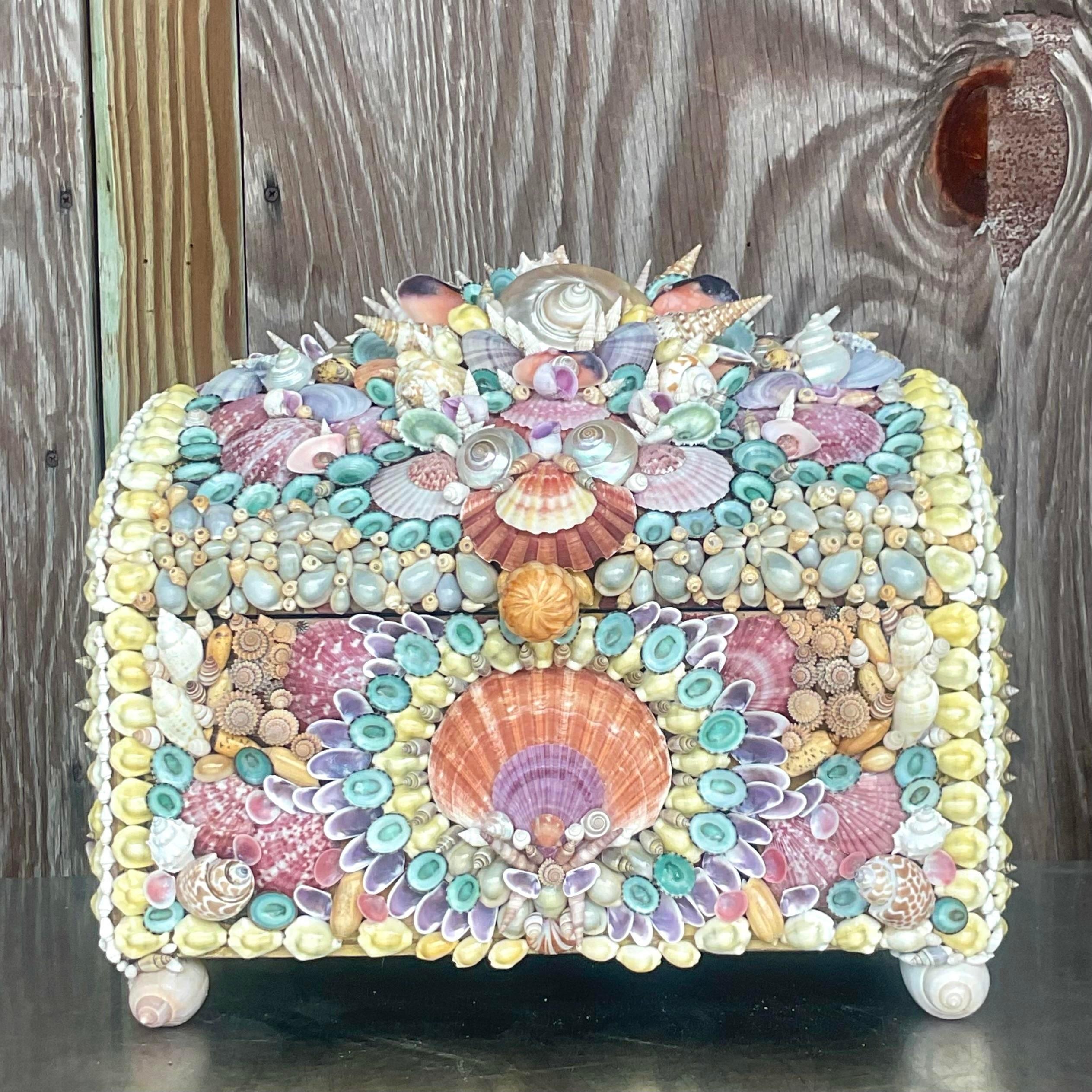 A chic and fantastic vintage shell box. An arched top for maximum storage. Beautiful hand placed shells in a brilliant range of colors. A really special piece. Acquired from a Palm Beach estate.