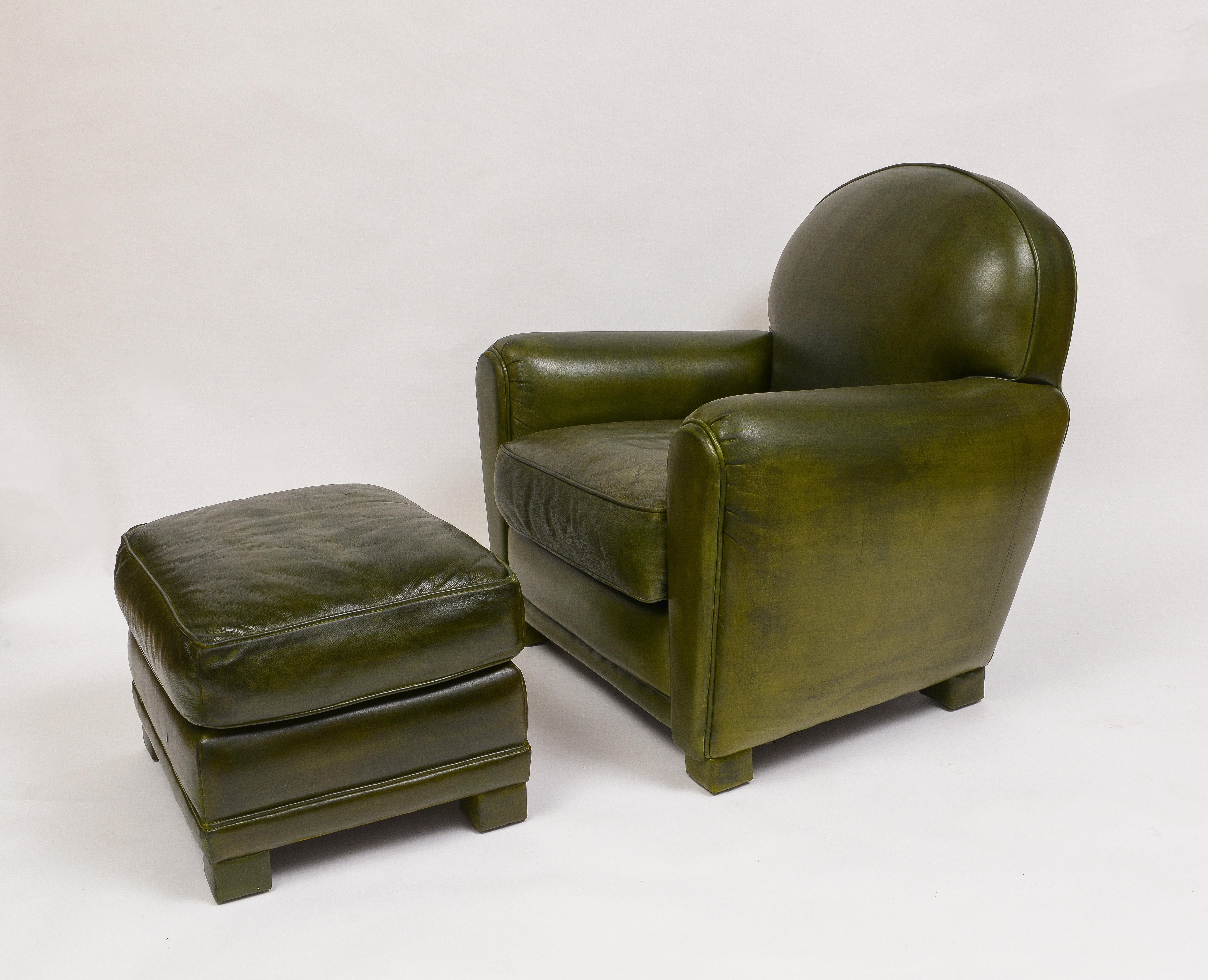 A pair of club chairs with matching ottomans by Grange
Very comfortable chairs dyed green
Arm chairs supported by square leather wrapped legs
Removable cushions on chairs - cushions fixed on the ottomans
Pair of Ottomans are W 18” x L 22” x H 15”
