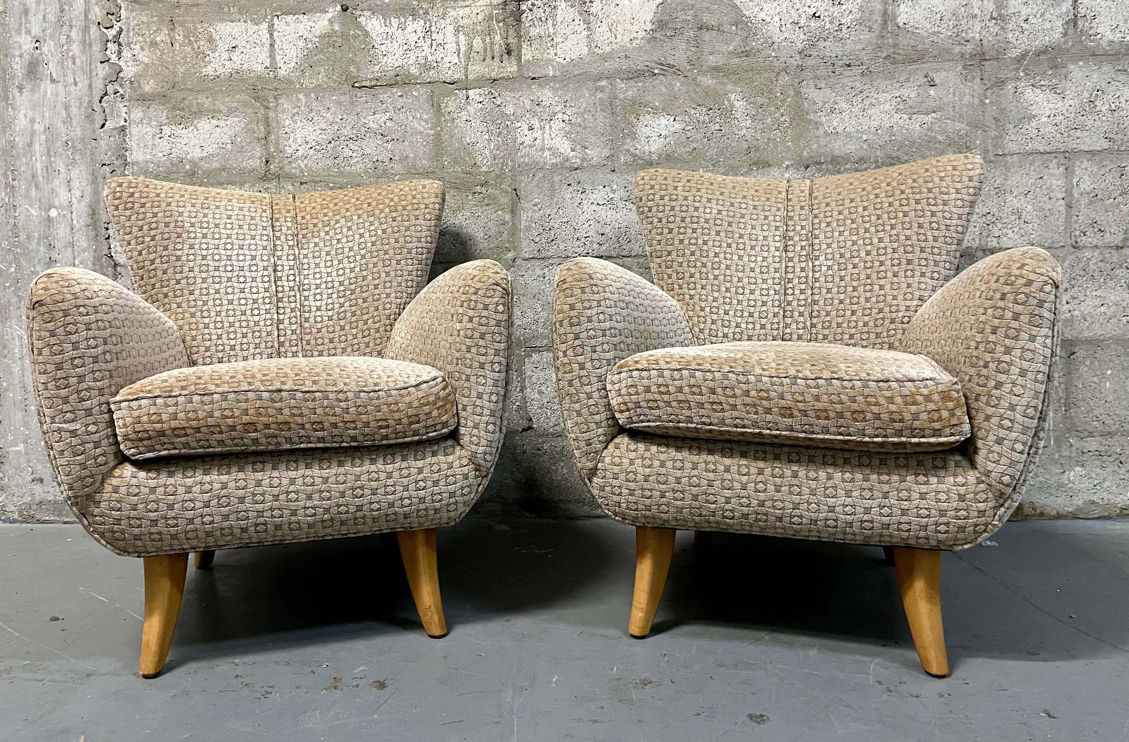 A Pair of Early 21st Century Lounge Chairs by Nancy Corzine in the Ernst Schawdron Style. Dated Year 2000 Feature the original velvet upholstery, an elegant midcentury inspired design with rounded lines and solid maple tapered curved legs. 
In good