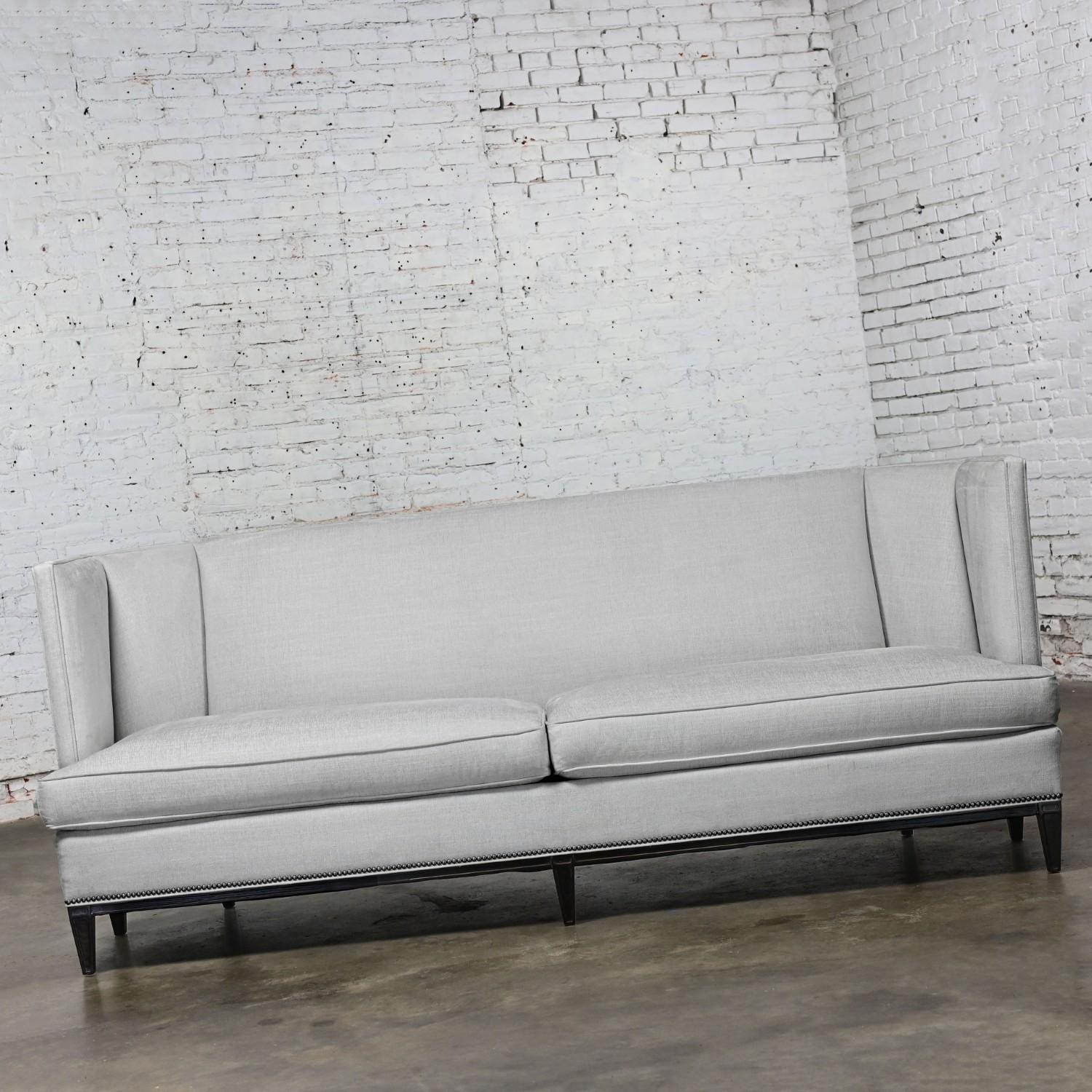 Incredible Early 21st Century Modern modified tuxedo style “Malbec Sofa” by Hickory Chair Furniture comprised of two loose feather wrapped poly foam zippered seat cushions, silver-gray to an oatmeal color linen like fabric, silver-toned nail head