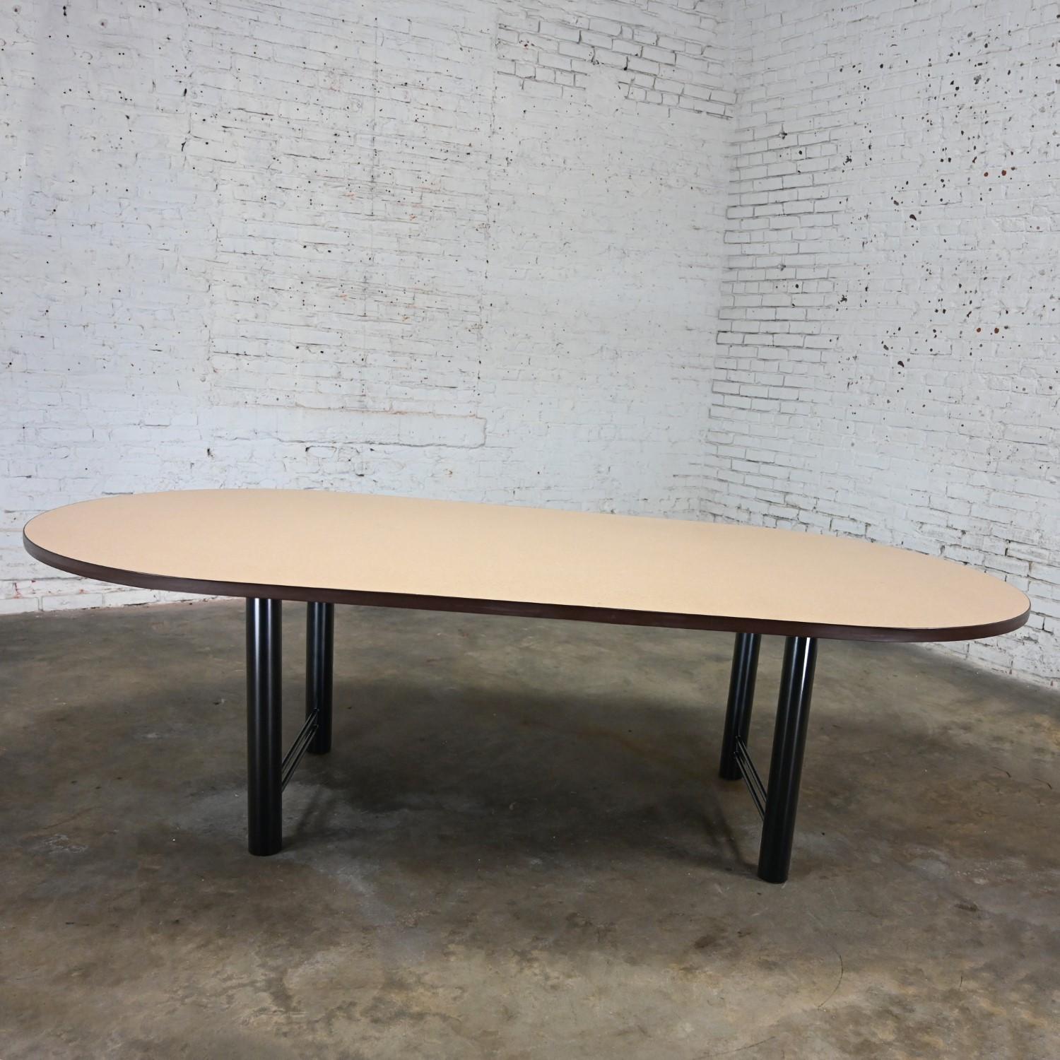 Marvelous Early 21st Century Modern Racetrack conference or dining table by Surfacetech with a 2 piece black painted metal cylindrical base and an oval laminate top. Beautiful condition, keeping in mind that this is vintage and not new so will have