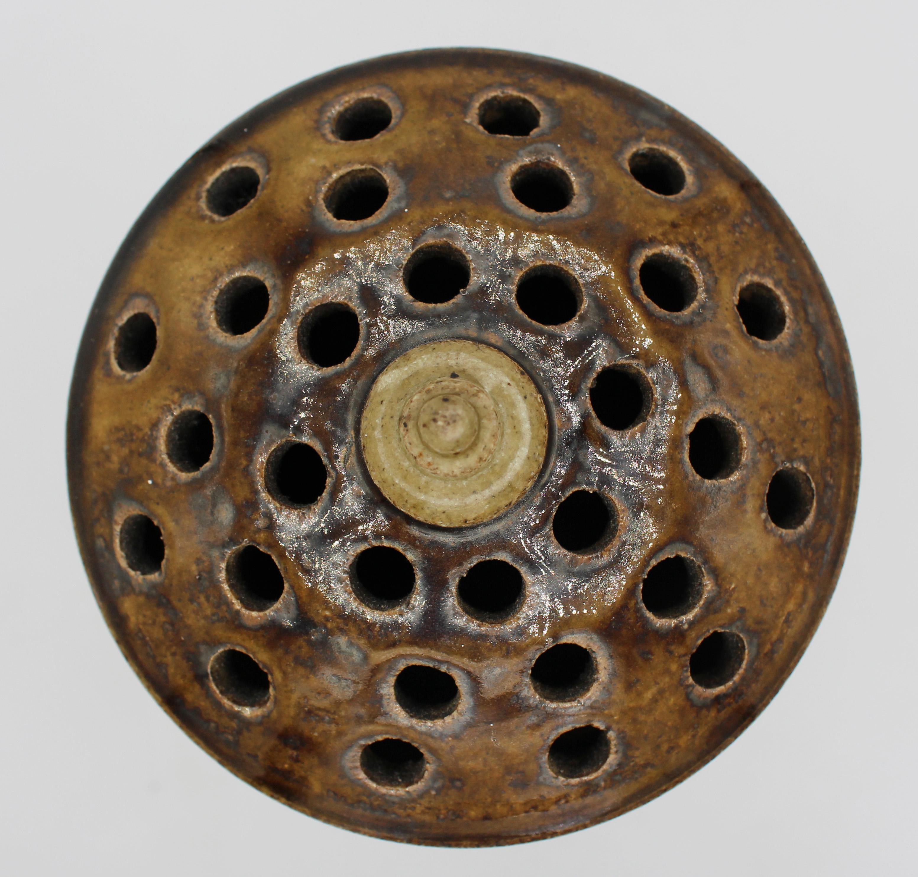 Early 21st century pottery flower stem vase by Daniel Johnston, Seagrove, NC. A stately example in earthy green to brown tones influenced by his travels to Thailan; this vase displays traditional Thai ceramic glaze colors, as well as coil