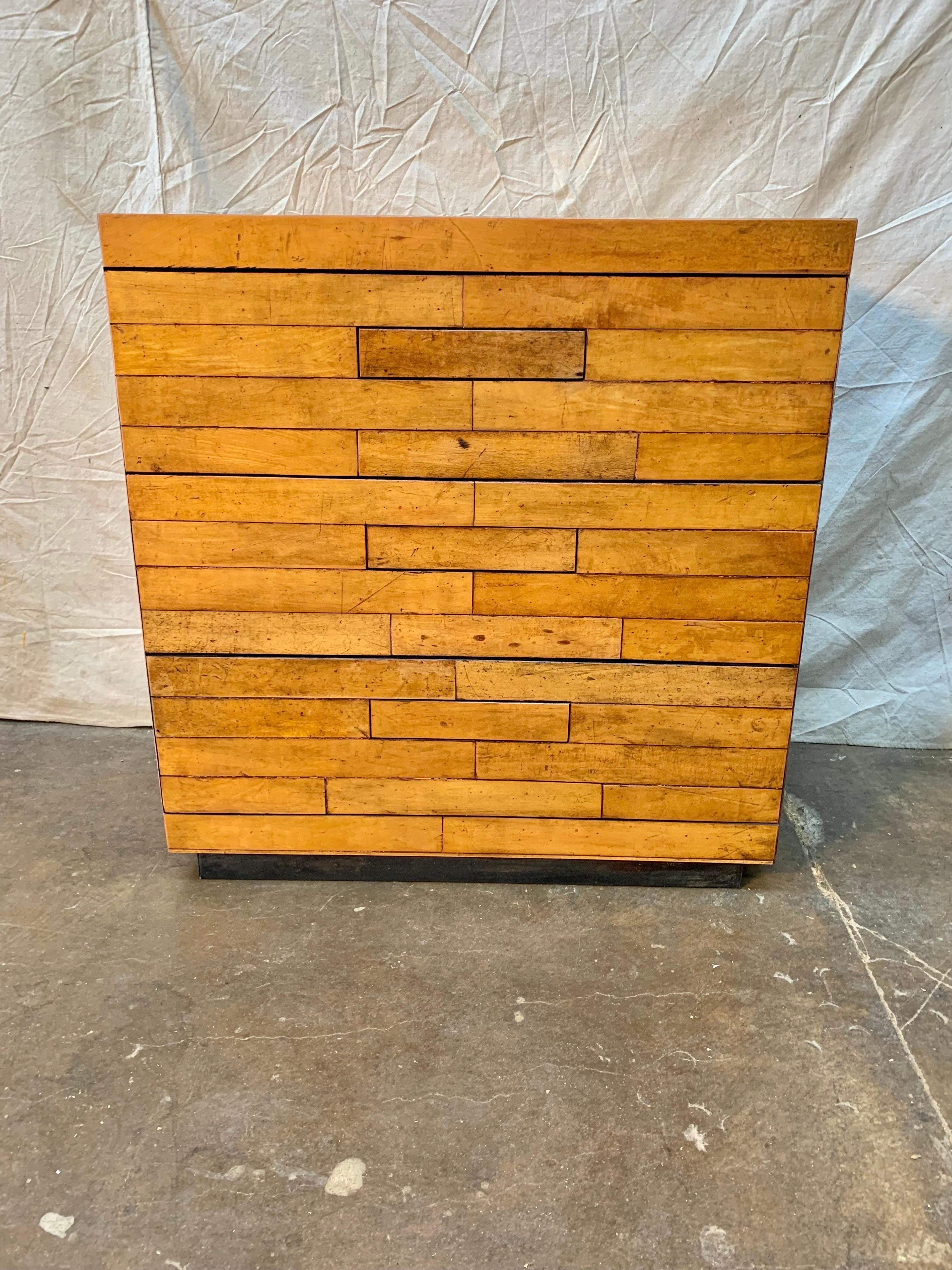 This Early 21st Century Timothy Oulton Chest of Drawers was made using reclaimed old English boarding school gym floors. The three drawer chest features hidden pulls which blend in seamlessly with the drawer facade. The drawers are easily operable