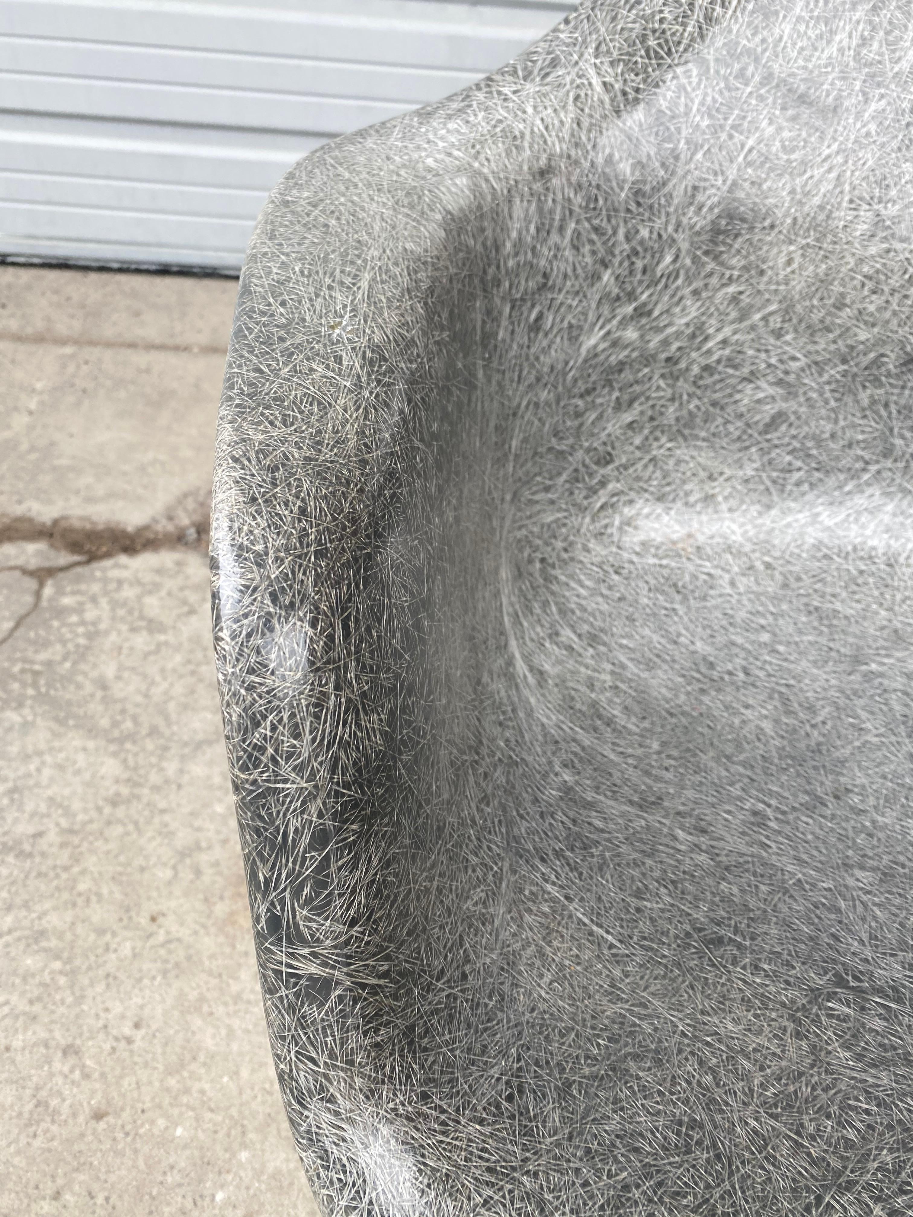 Early 2nd generation X base elephant gray arm shell lounge chair by Charles Eames for Herman Miller. Amazing condition, featuring early solid iron X base, .Amazing color. Elephant gray fiberglass arm shell with amazing exposed spun fibers, clean,