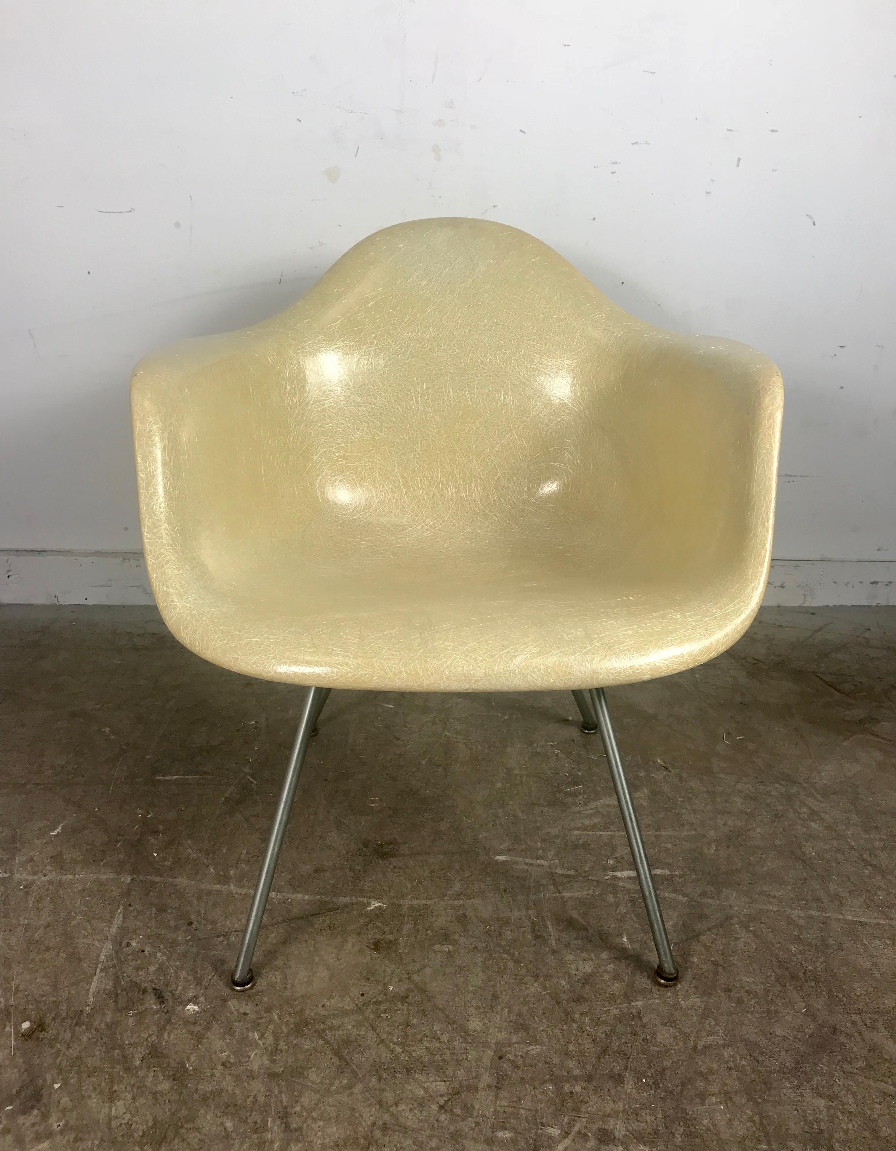 Early 2nd generation X base translucent arm shell lounge chair by Charles Eames for Herman Miller. Amazing condition, featuring low aluminum X base, large domes of silence shock mounts. Retains all four early foot glides, see through translucent