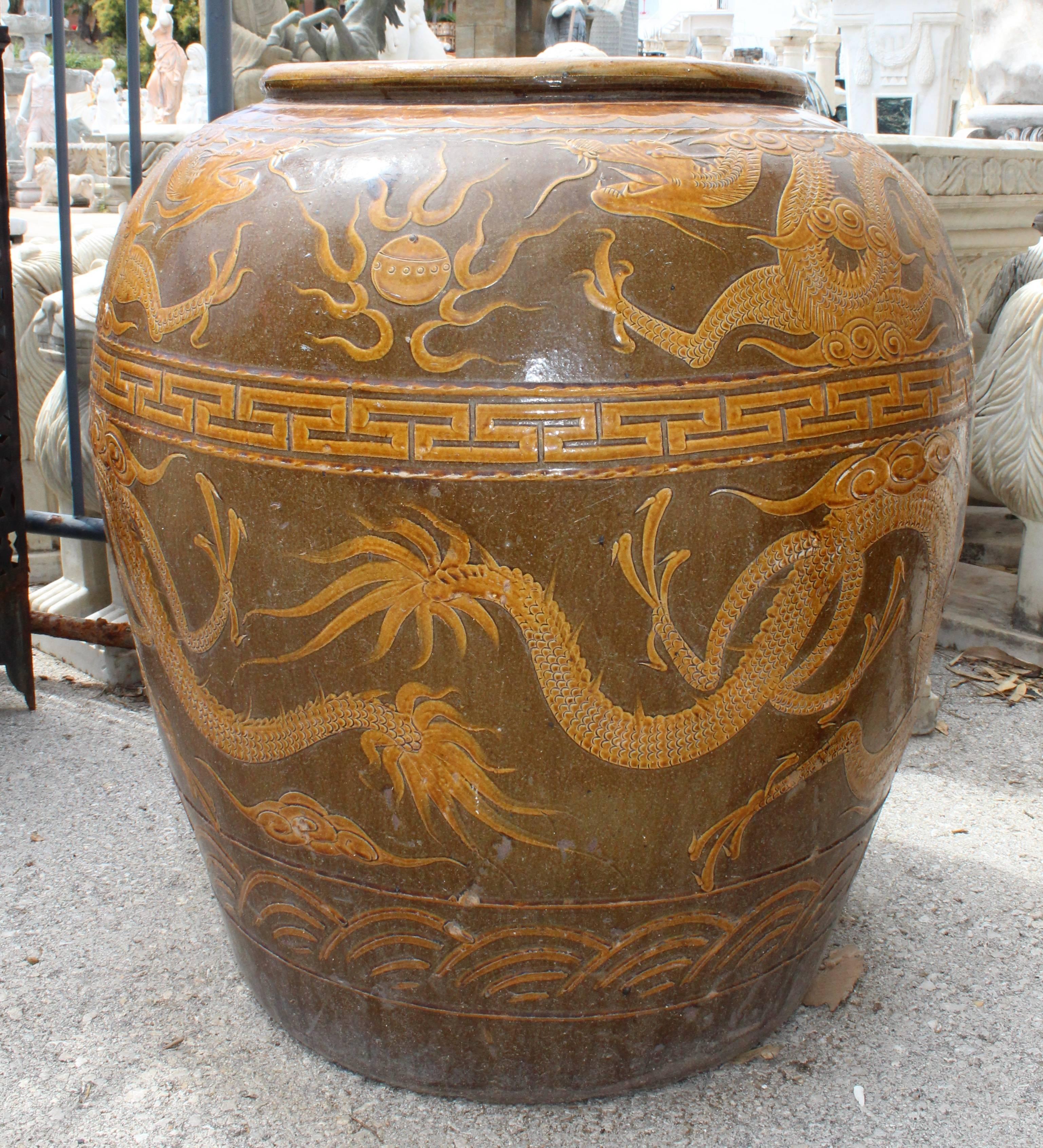 Antique glazed ceramic planter from the early 20th century representing classical oriental dragons.
  