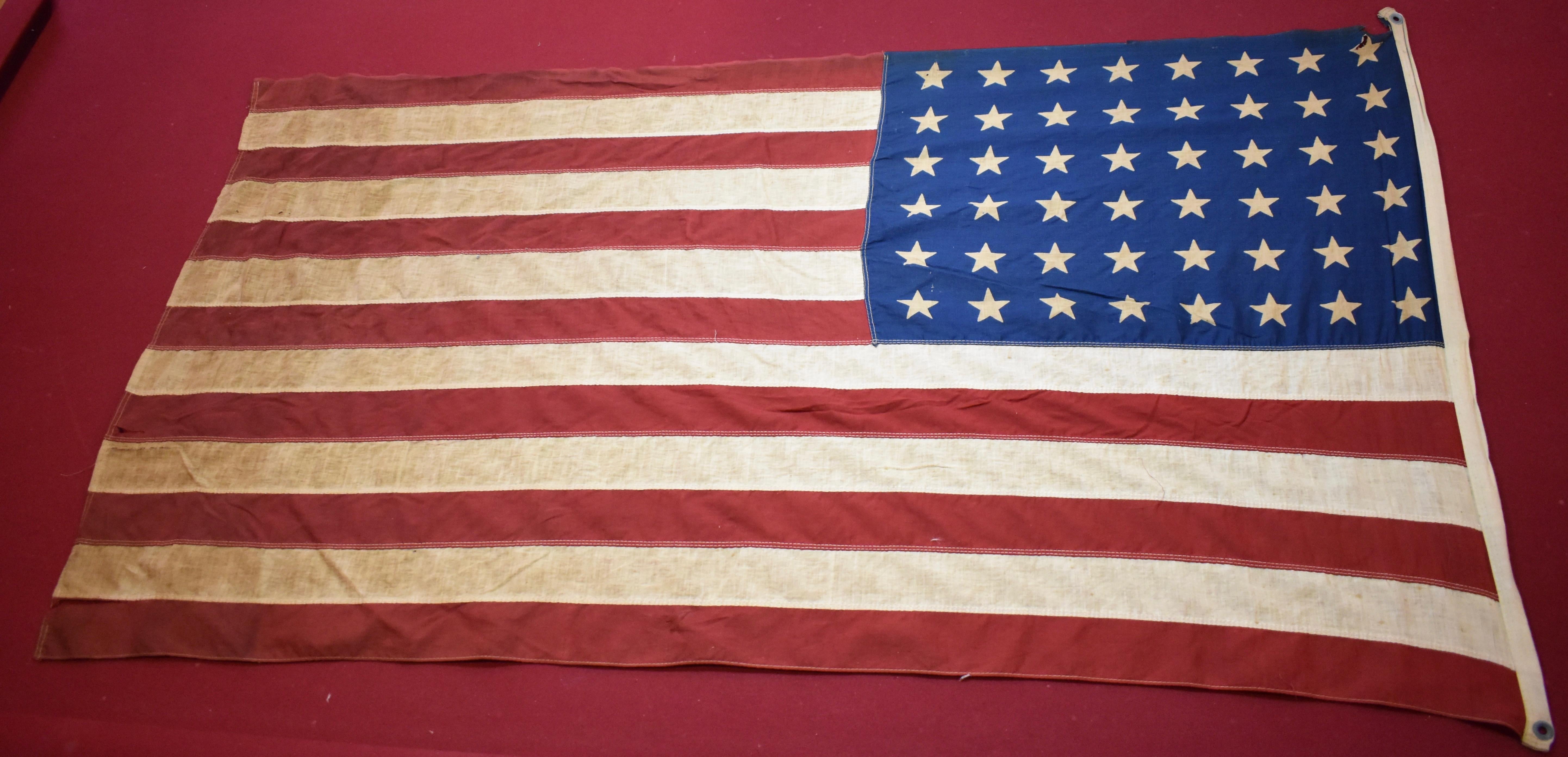 Early 48 star US Flag. These range from 1912-1959. This example looks like the earlier end of that spectrum. Fabric is brittle and has a few tears in it. If you are looking for a vintage flag with patina to frame, this is the one. All the character