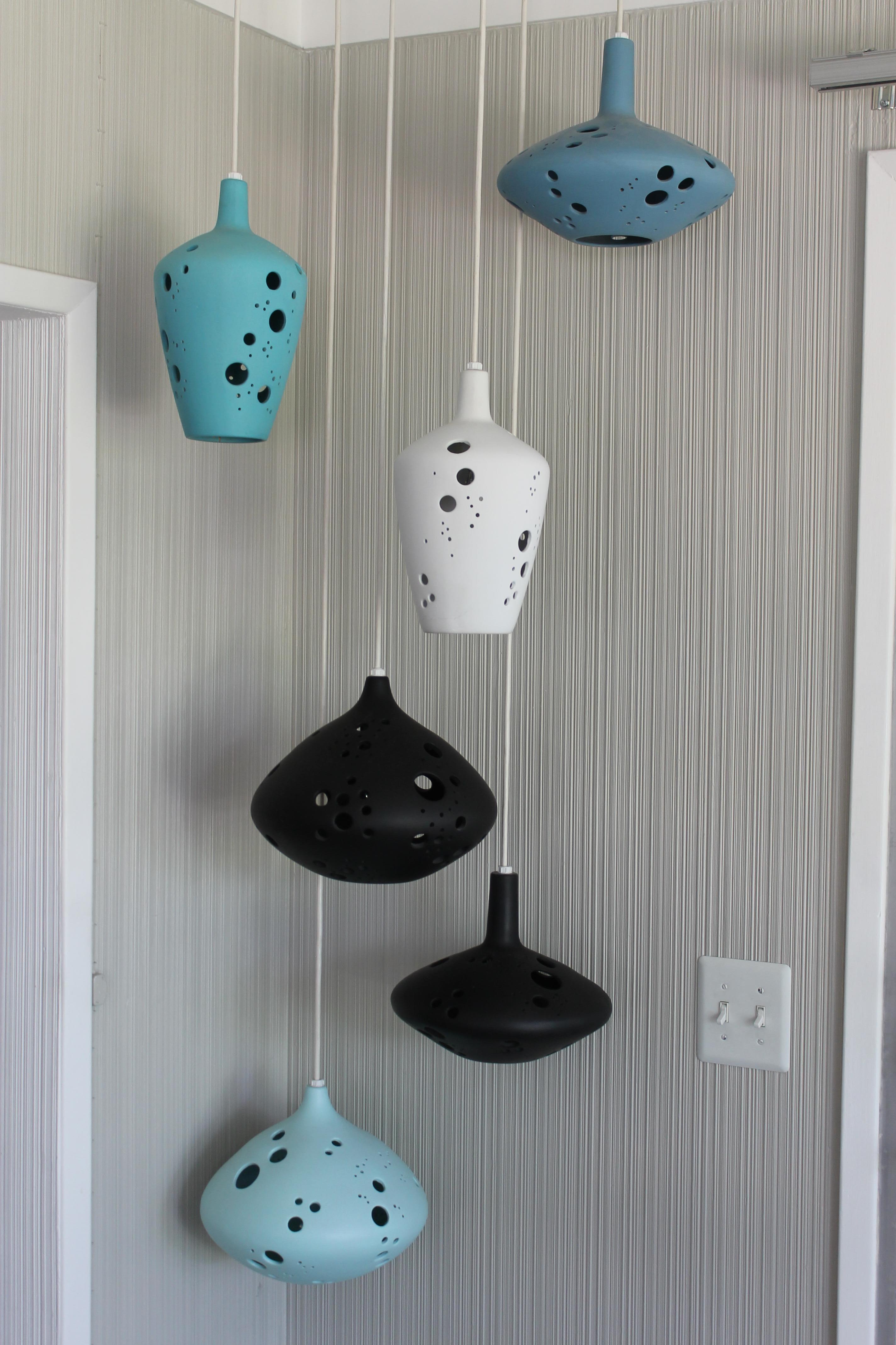 Six very rare ceramic pendant lights from the early 1960s. Three shapes, two of each, in shades of turquoise, black and white. Dimensions vary from 11