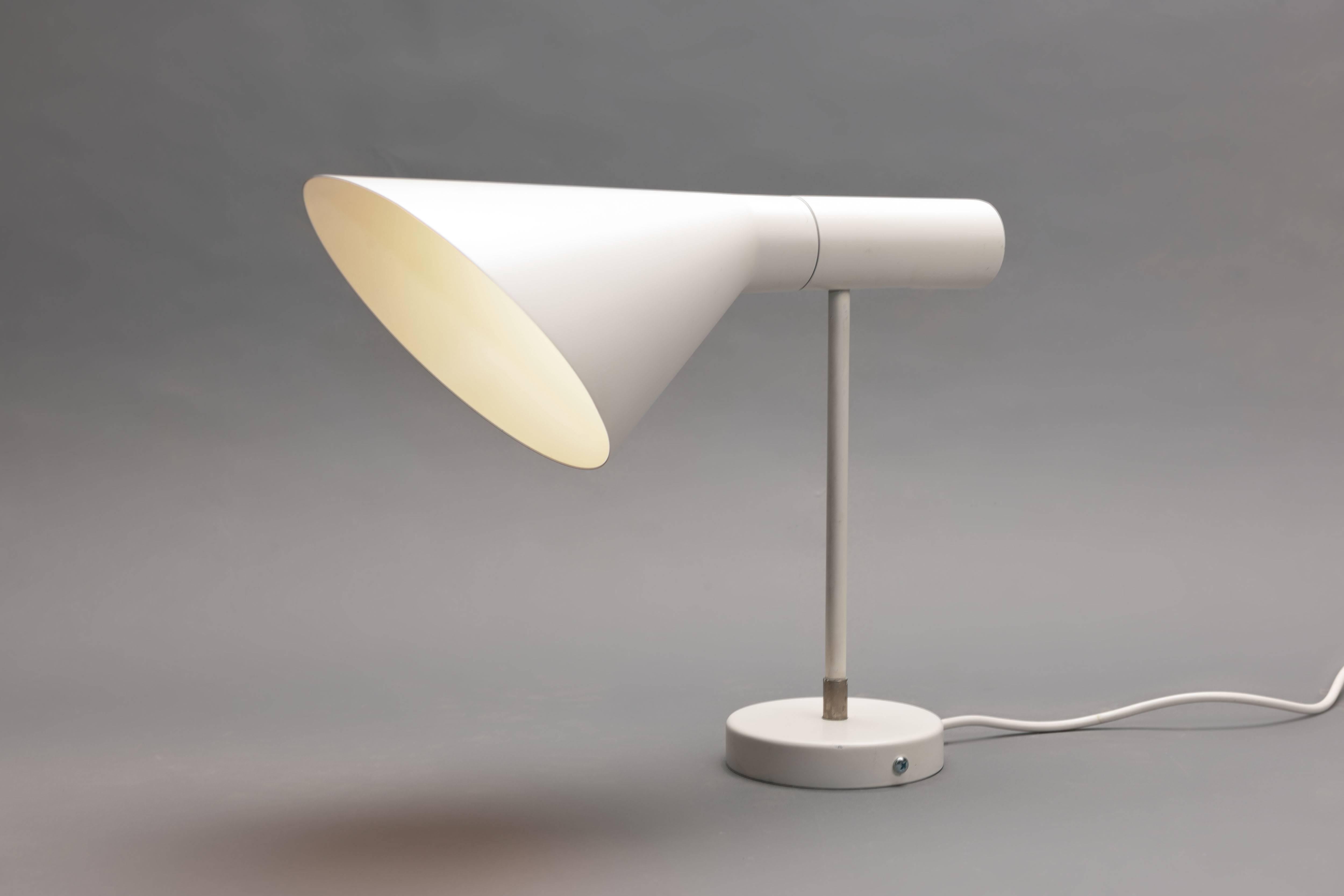 Early - older versions (these are larger sized) white 'Visor' / AJ wall lamp by Arne Jacobsen, originally designed in 1958 for the Sas Royal hotel in Copenhagen executed by Danish manufacturer Louis Poulsen. 
Measures: Depth 35 cm, length 30 cm,