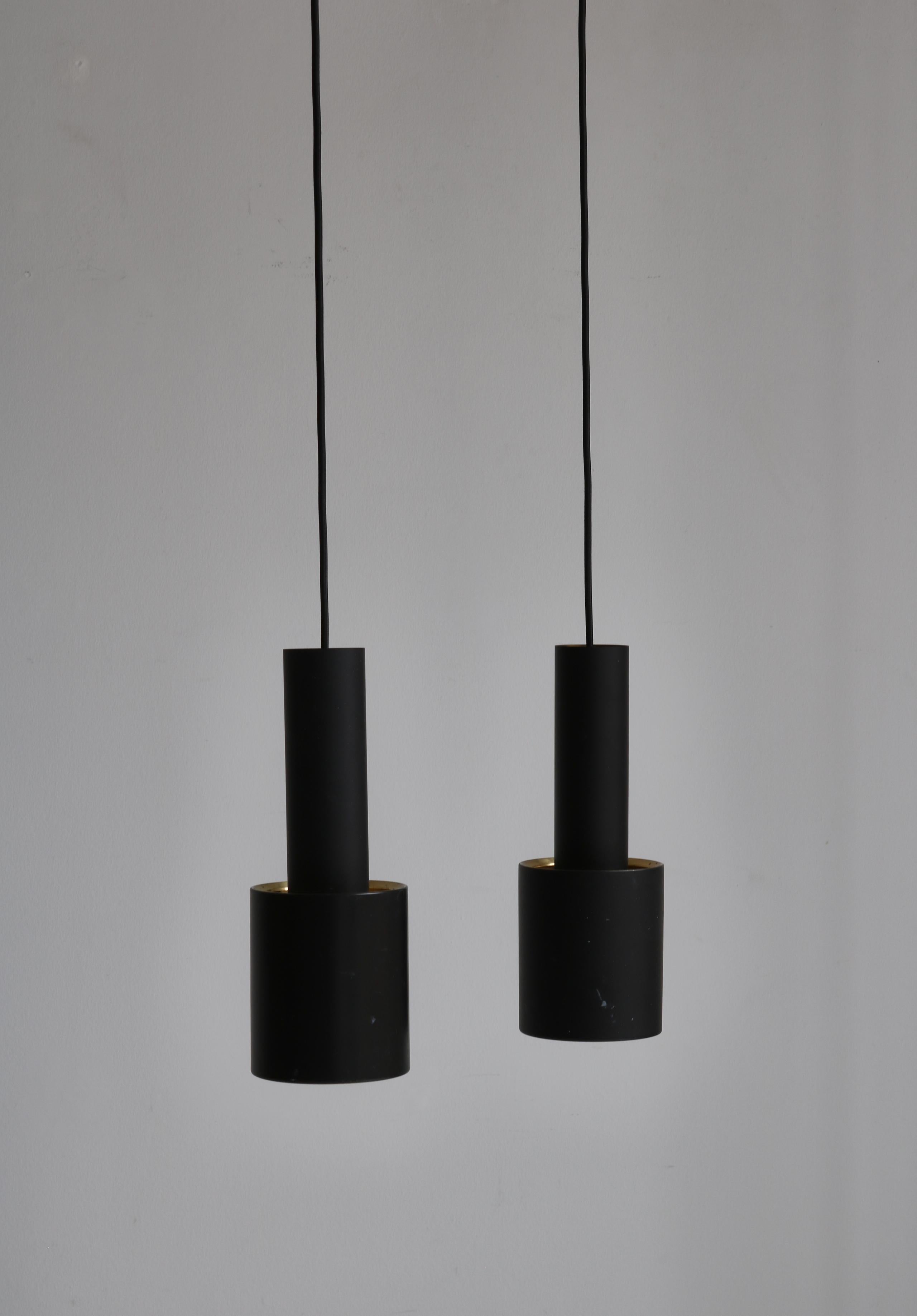 Rare and early set of brass pendants by Alvar Aalto. This pair manufactured by Louis Poulsen, Copenhagen in the 1960s as model number 