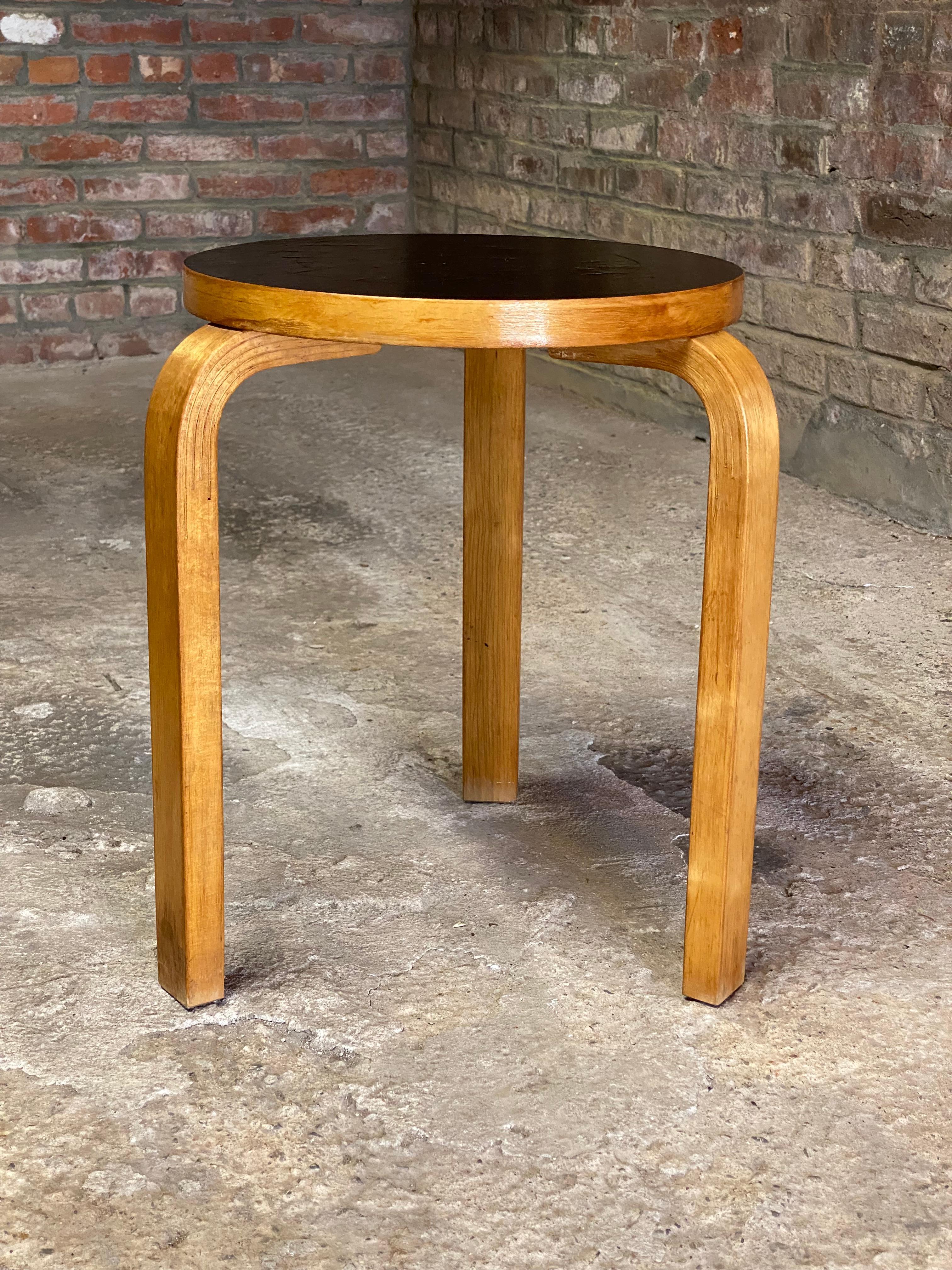 A good and early example by Alvar Aalto for Artek, Sweden bentwood birch and black laminate Stool 60. Circa 1950. Fully signed on the bottom with ink stamp, Aalto Design, Artek, Made in Sweden, 60. Signature bentwood legs featuring the finger joint