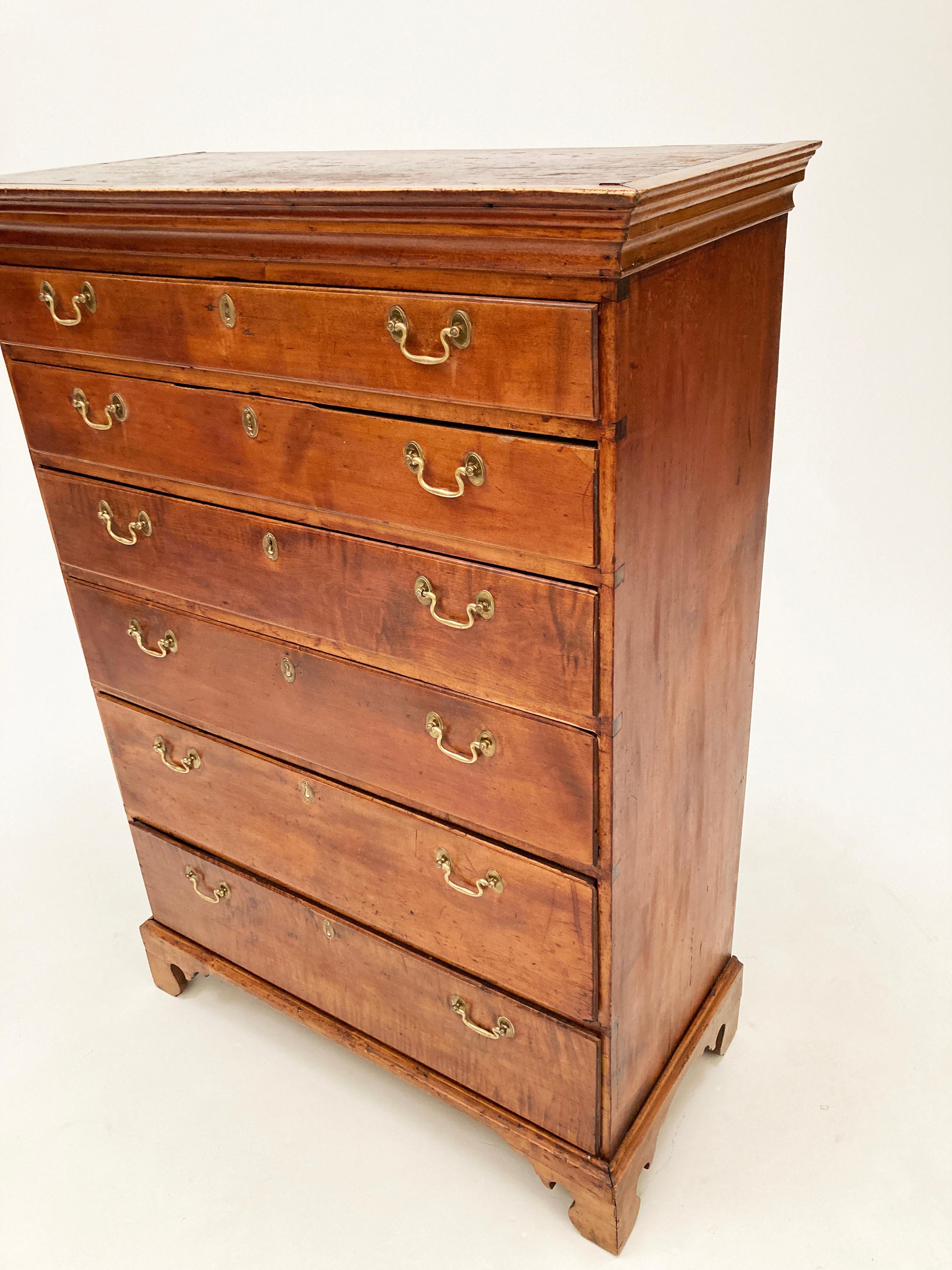 Stunning historic pieces like this don't come along every day! This c. 1780's Tiger Maple Chippendale tall dresser with 6 drawers with brass drawer pulls was designed and built in the New England area around 1780. It's birthplace was most likely New