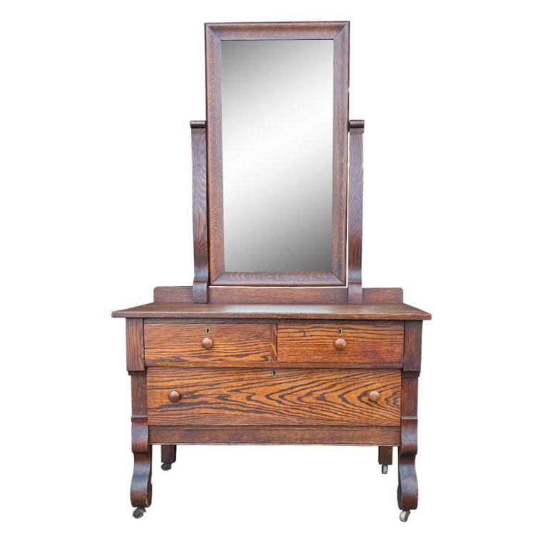 A stunning example of early American mission-style furniture. This piece is created from Tiger Oak and features three low drawers with a locking mechanism. The top is solid oak often referred to as 