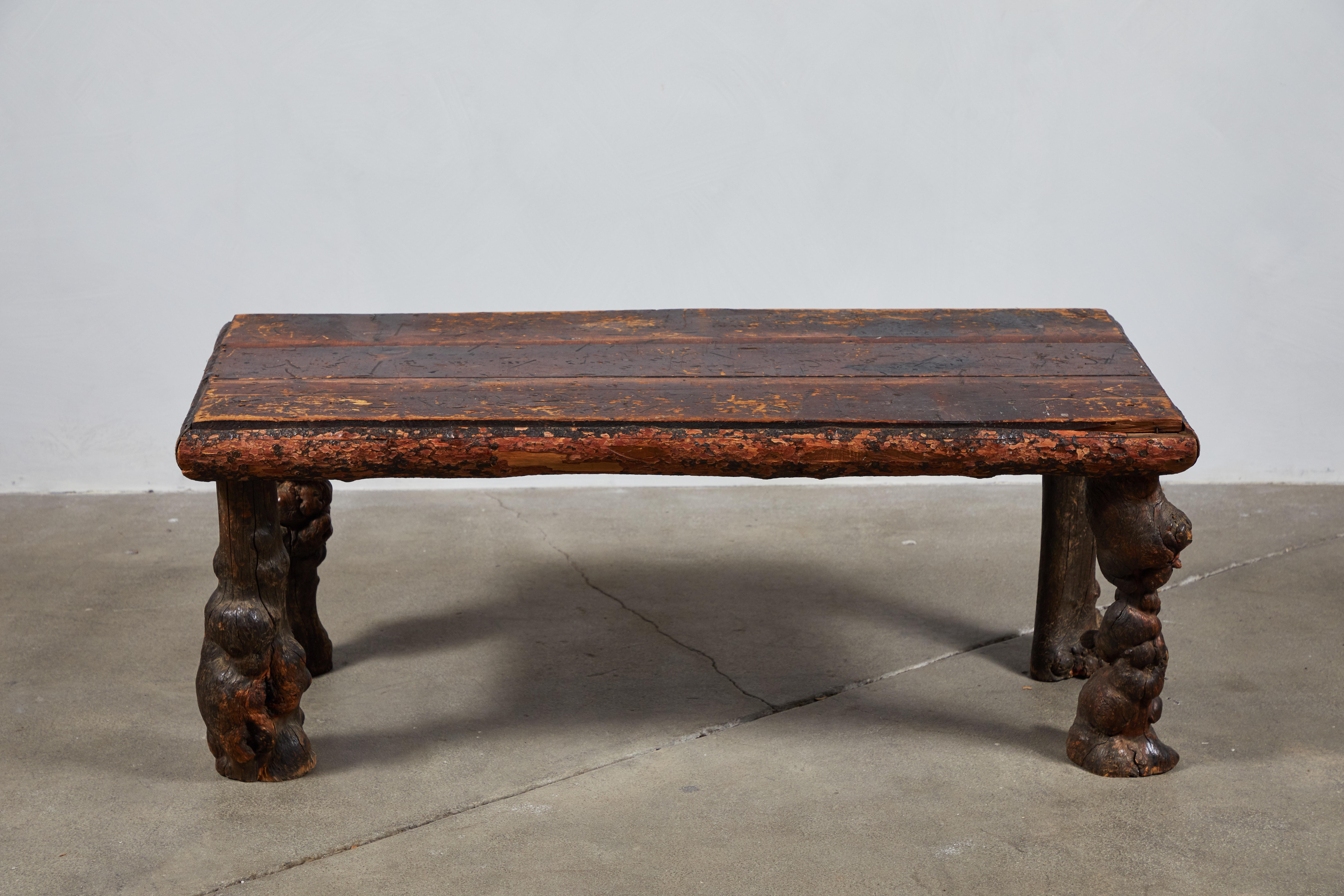 Unique tall table with unique burled wood legs and chunky top. Original distressed finish. The table is tall enough to be a bench as well.