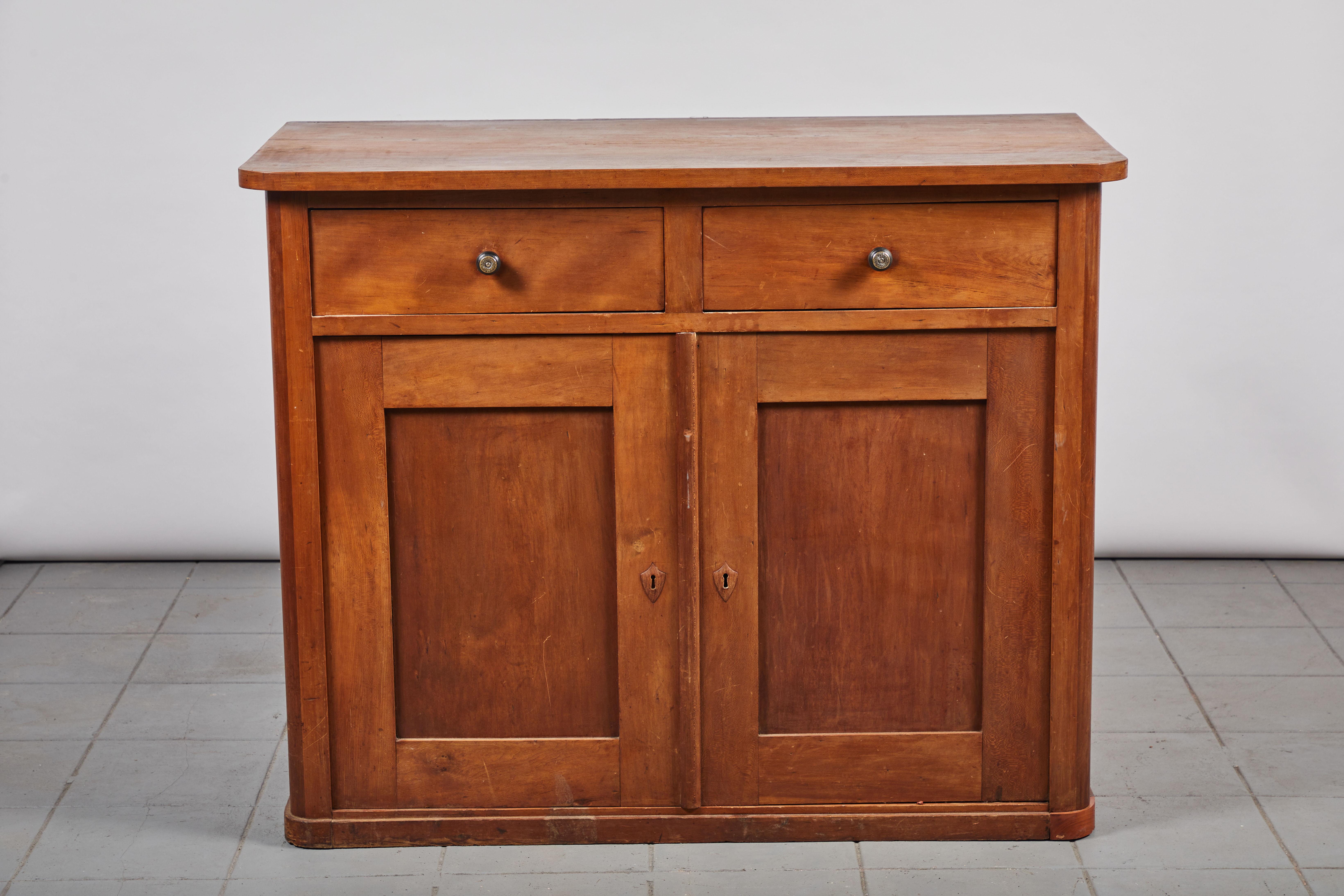 Early American cherry two-door two-drawer cabinet.