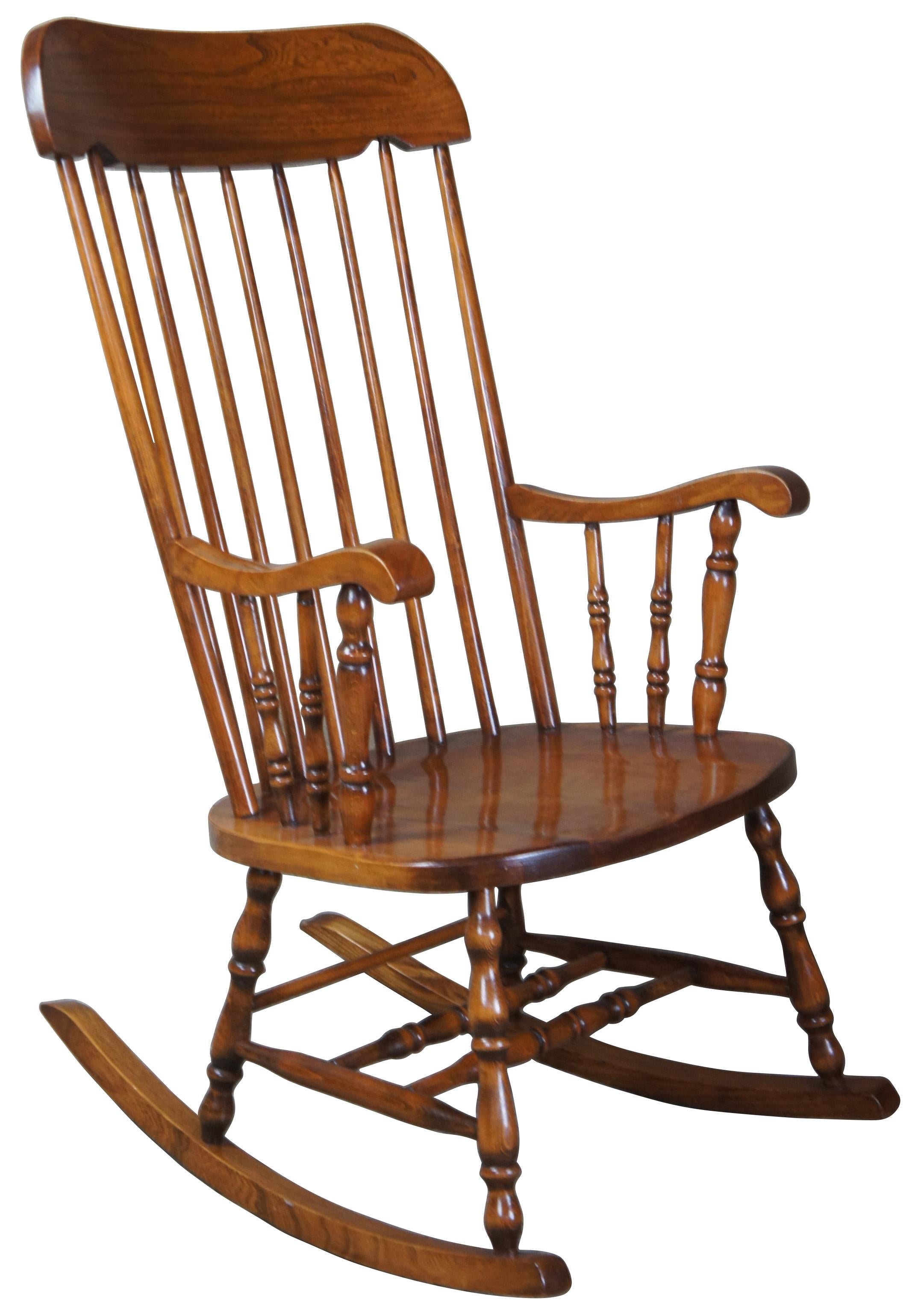 Mid 20th century American country rocking chair. Made from maple with a spindle back and contoured arms. Measure: 41