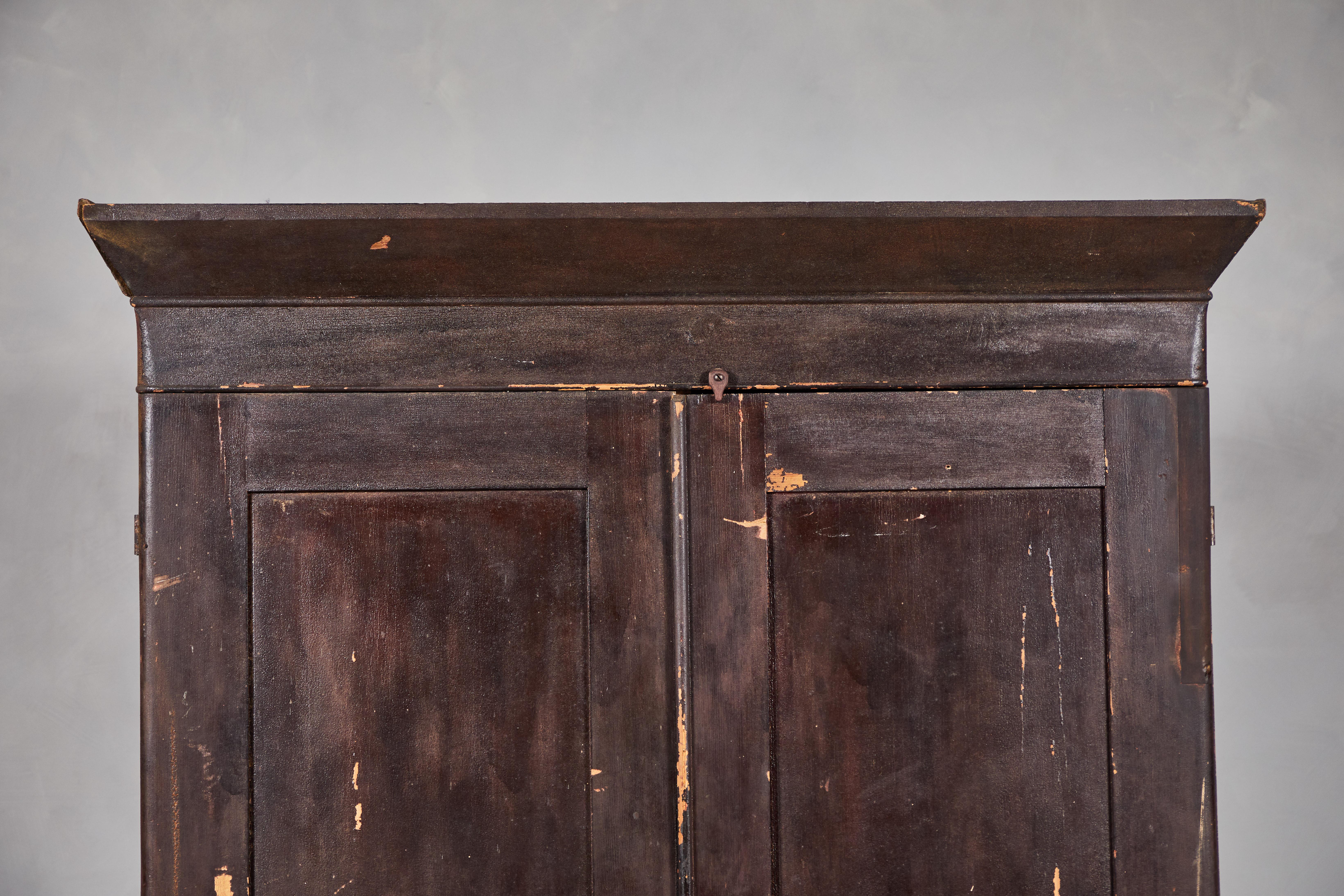 Distressed Early American Armoire with crown moulding. Original dark stained exterior with unfinished Douglas Fir interior. Armoire offers two lower drawers.