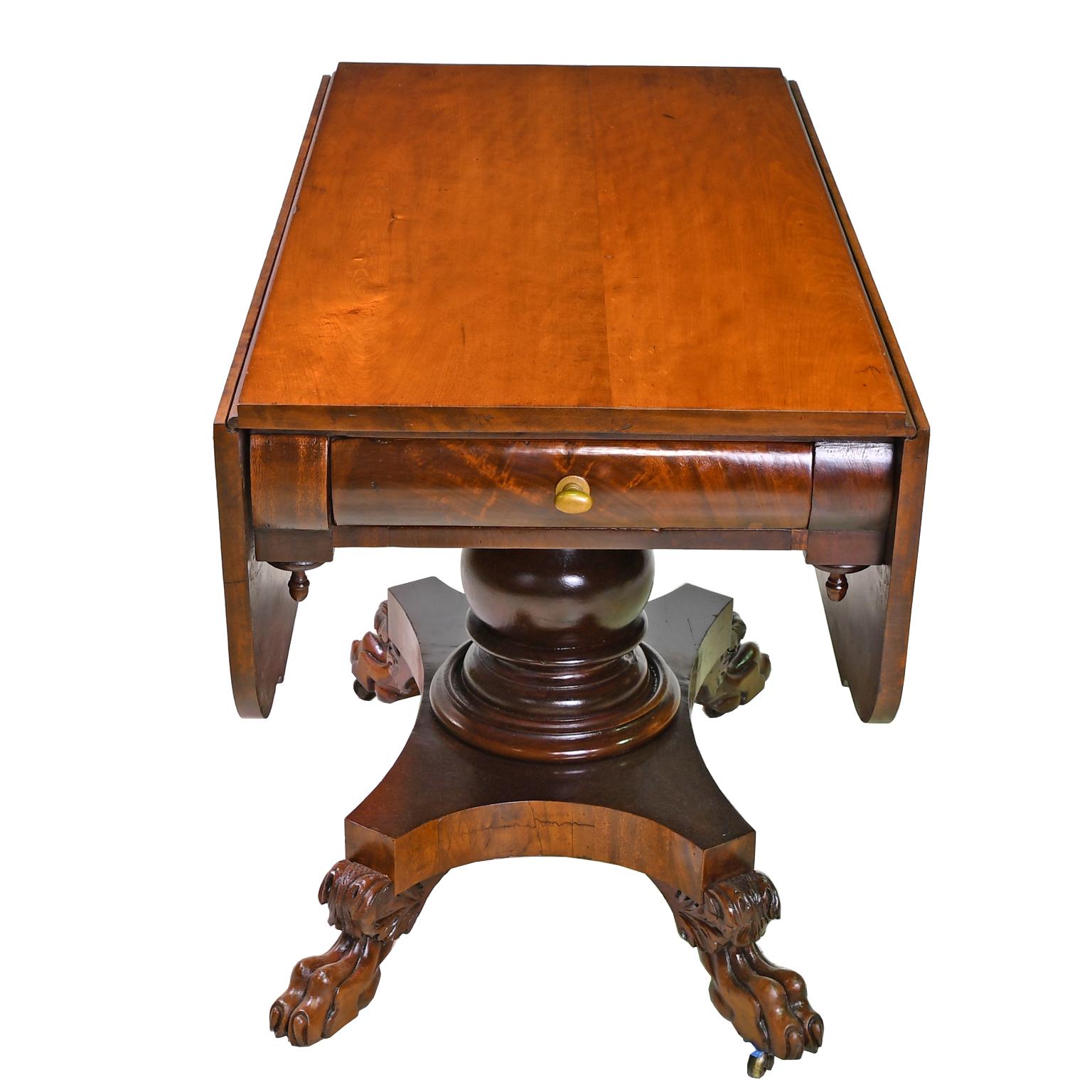 A handsome early American empire/classical pembroke table in fine West Indies mahogany with solid rectangular top offering two hinged drop-leaves with 