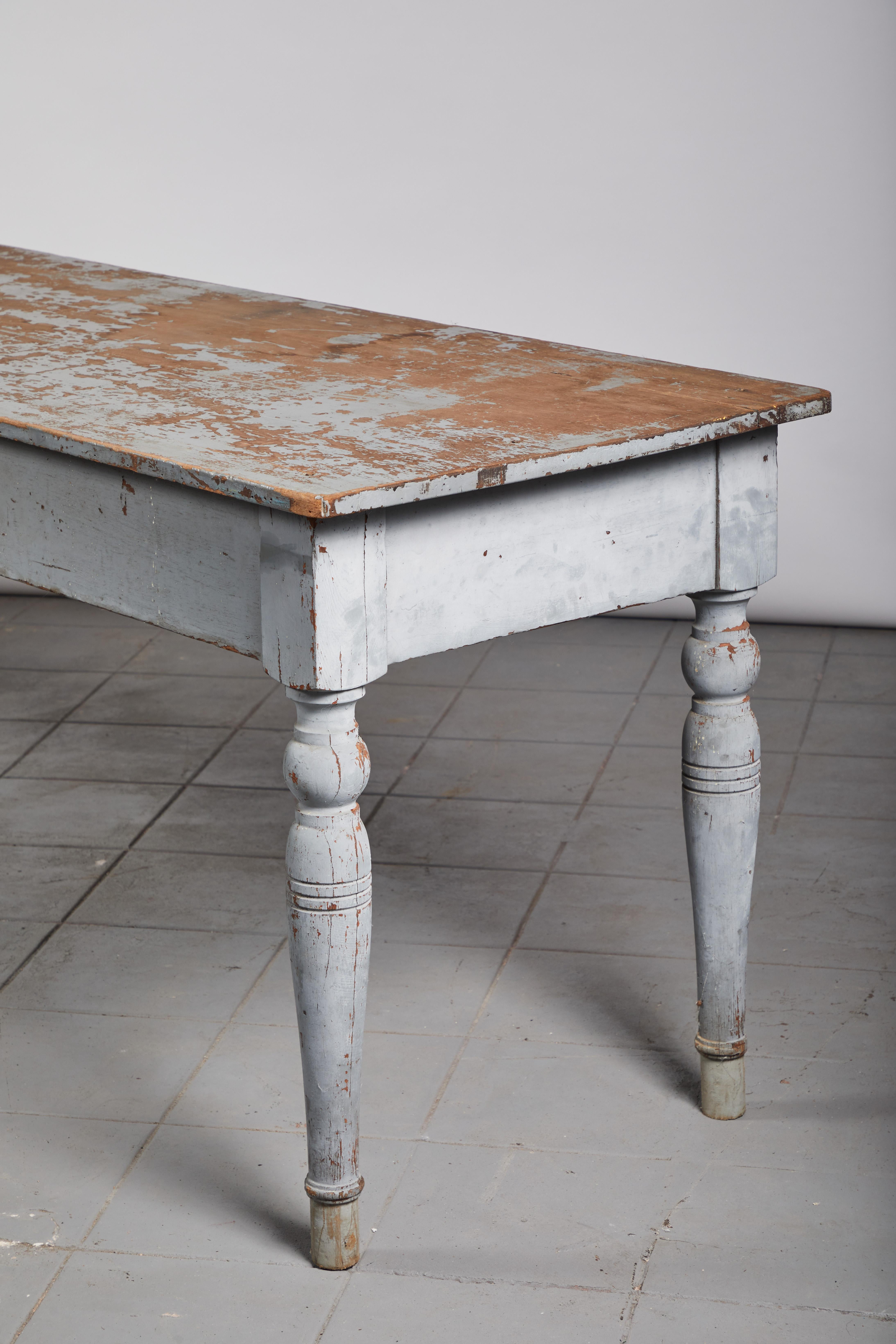 Early American rustic grey farm table with turned legs.