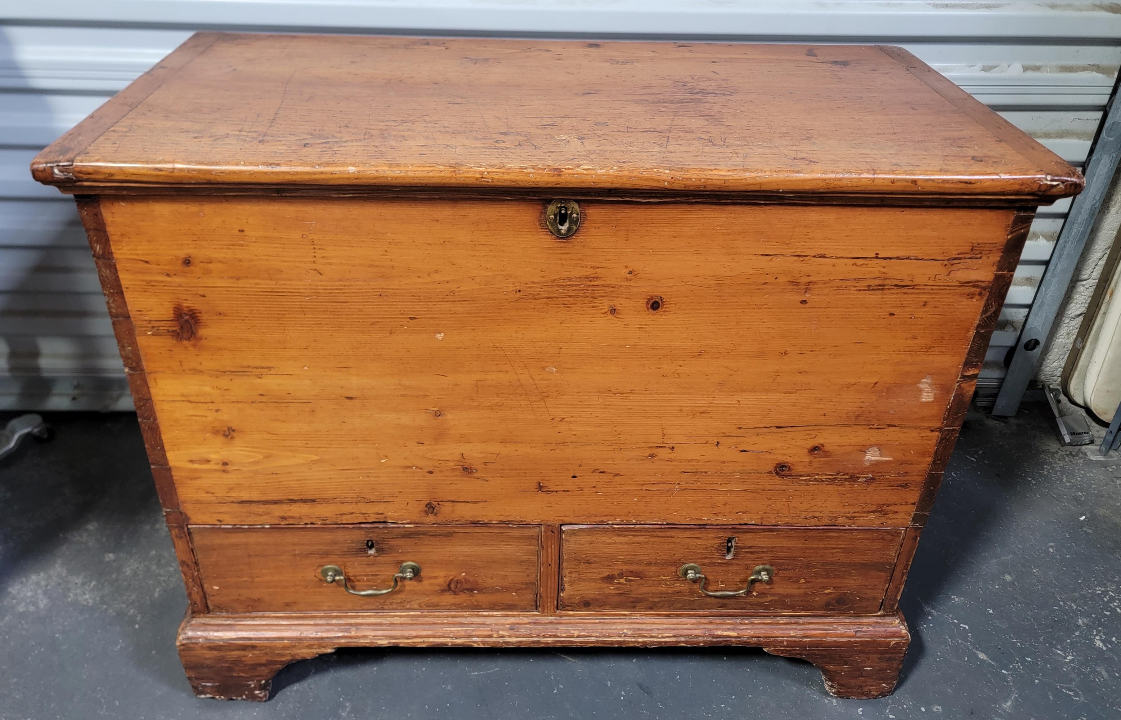 Old world primitive charm to this Early American pine blanket chest. Original hand wrought iron hinges, original lock. Hand made with hand scribed dovetail joinery along all four corners. Beautiful, warm patina to finish. 