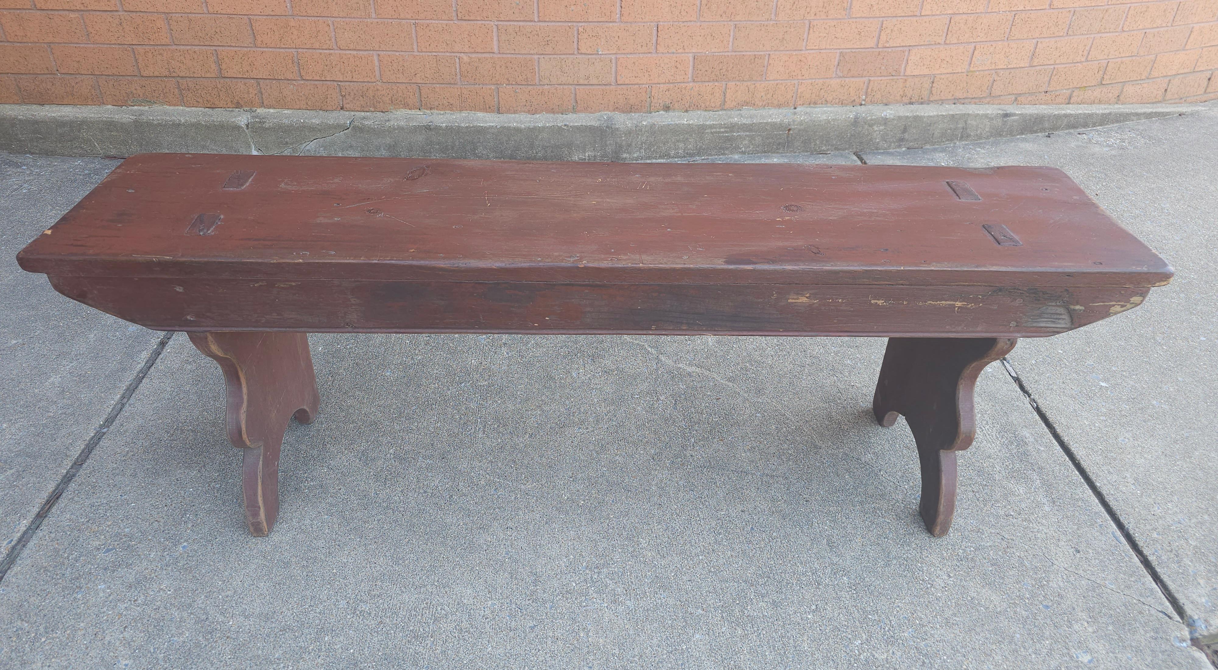 An Early American Style primitive two seater bench measuring 50