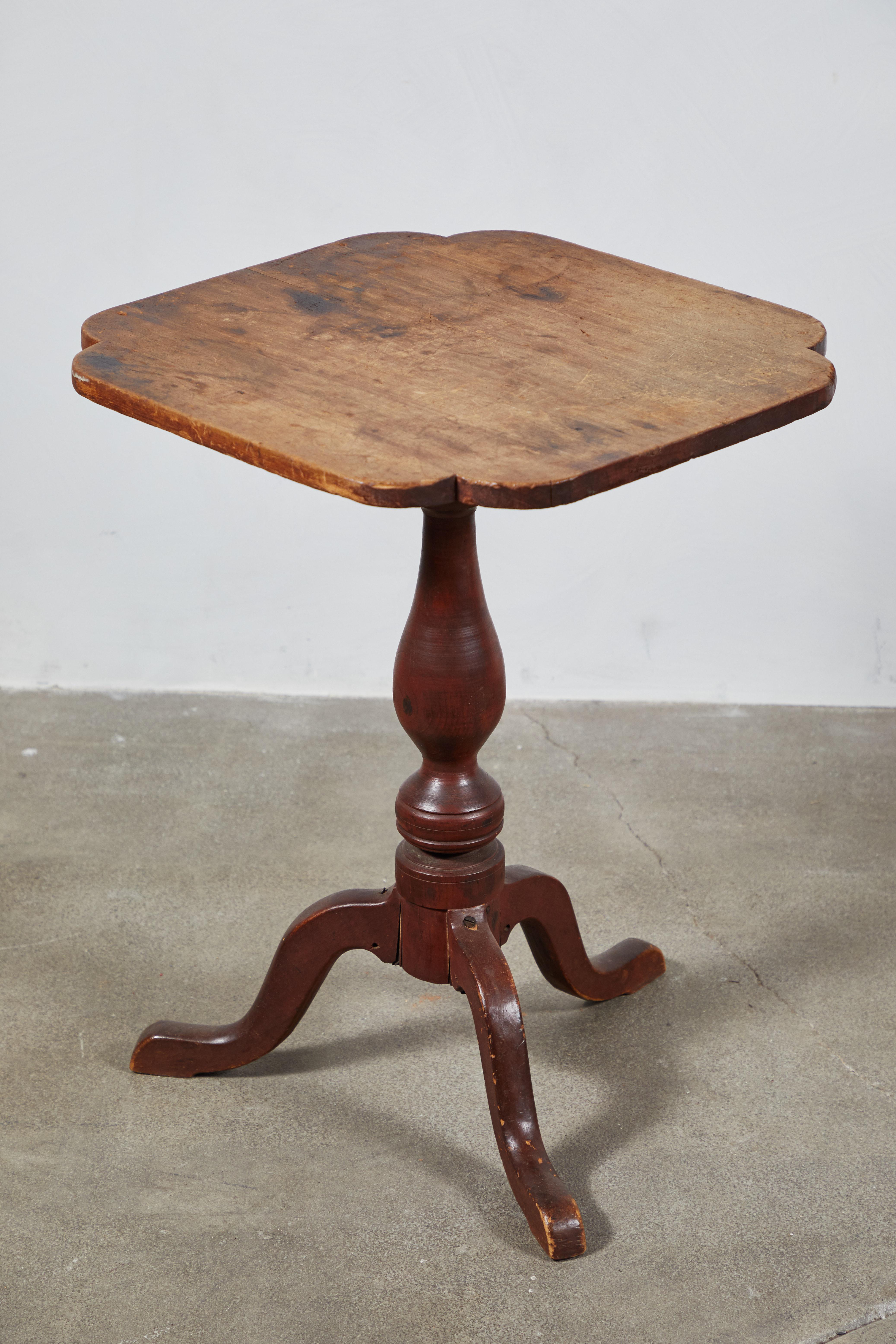 Early American Queen Ann style side table with scalloped radius corners and turned pedestal base. The top reflects the natural patina of an antique table.

