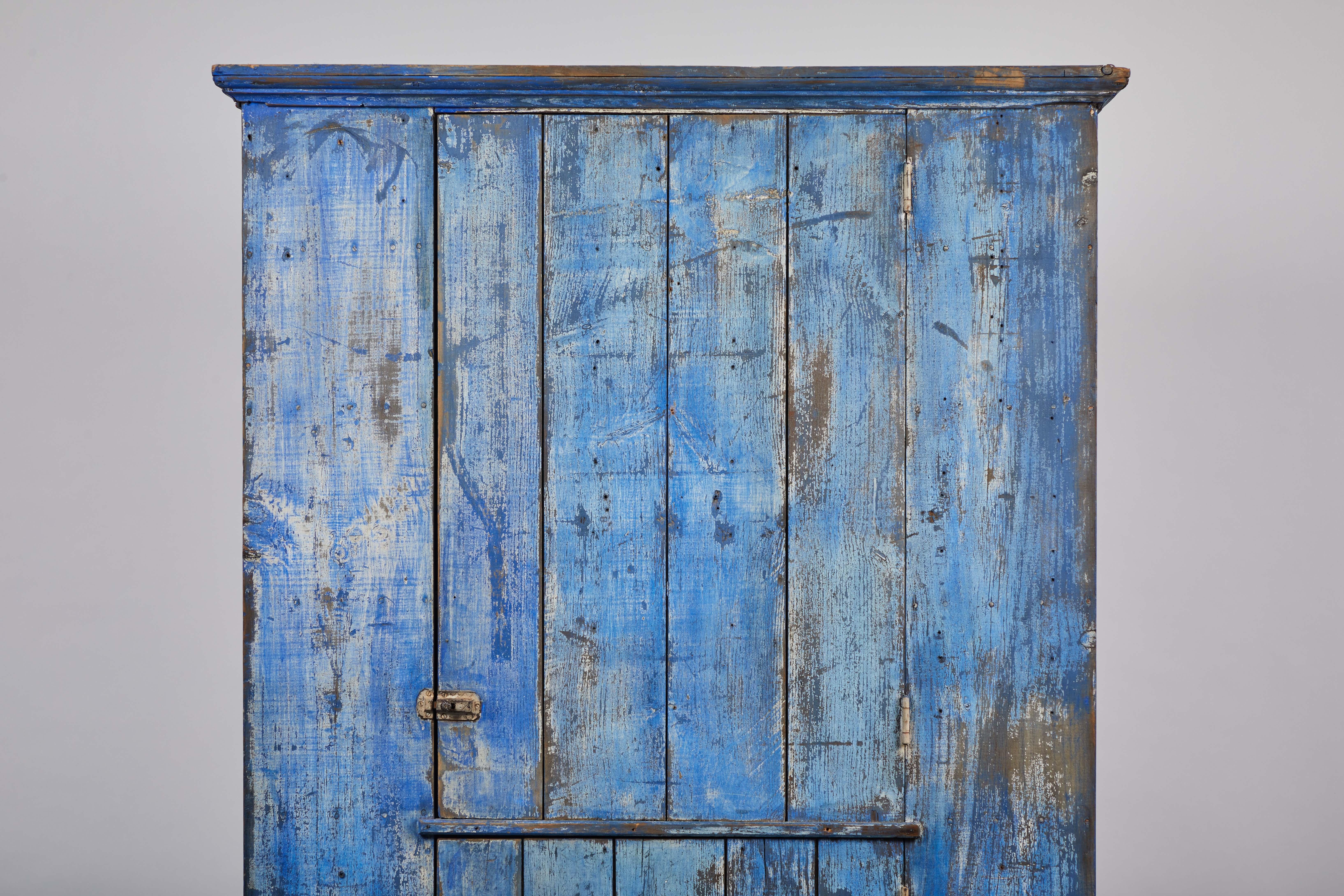 Early American rustic painted cobalt blue two-door cabinet.