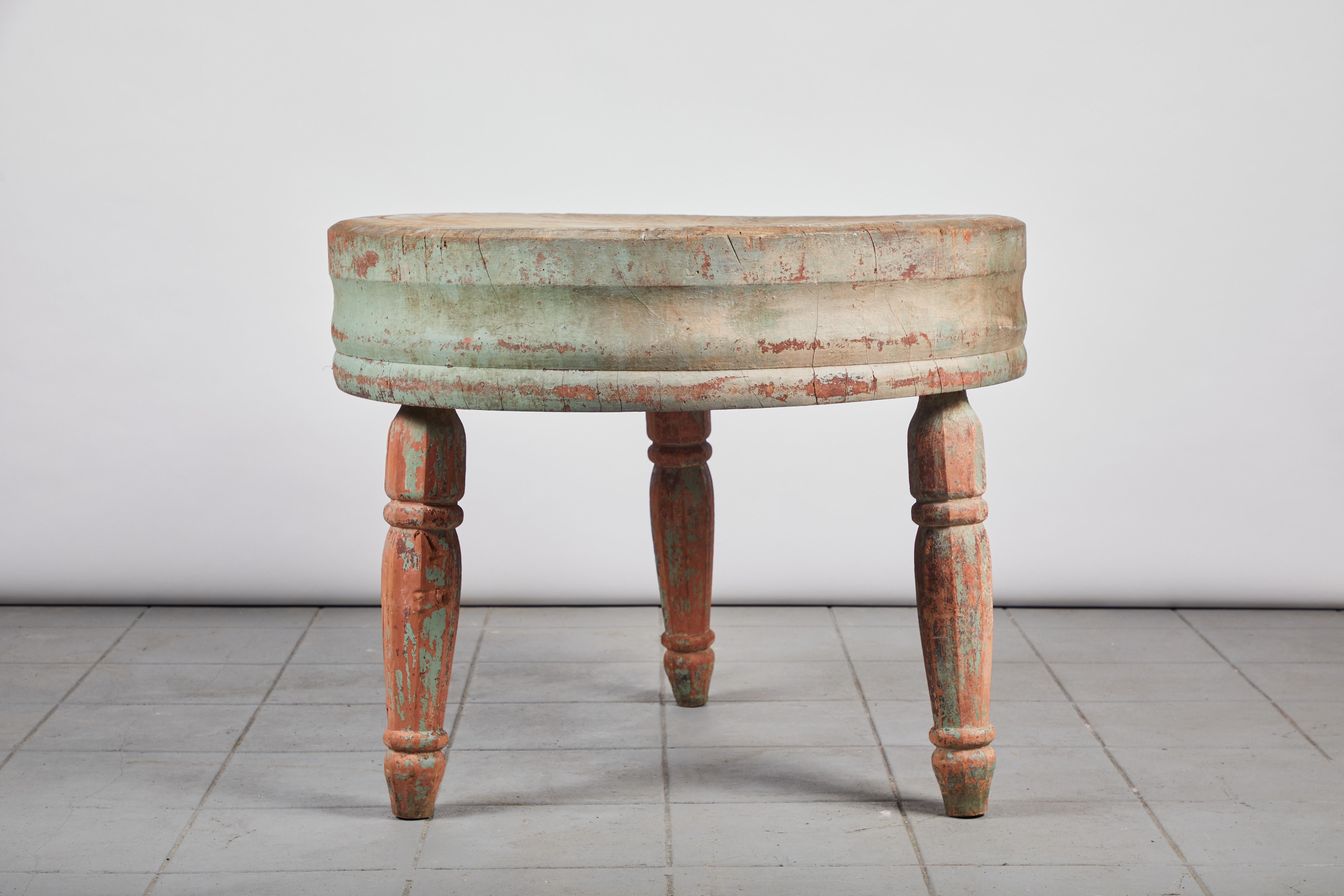 Rustic early American round butcher block table, sits on three legs. Original finish adds to the patina.