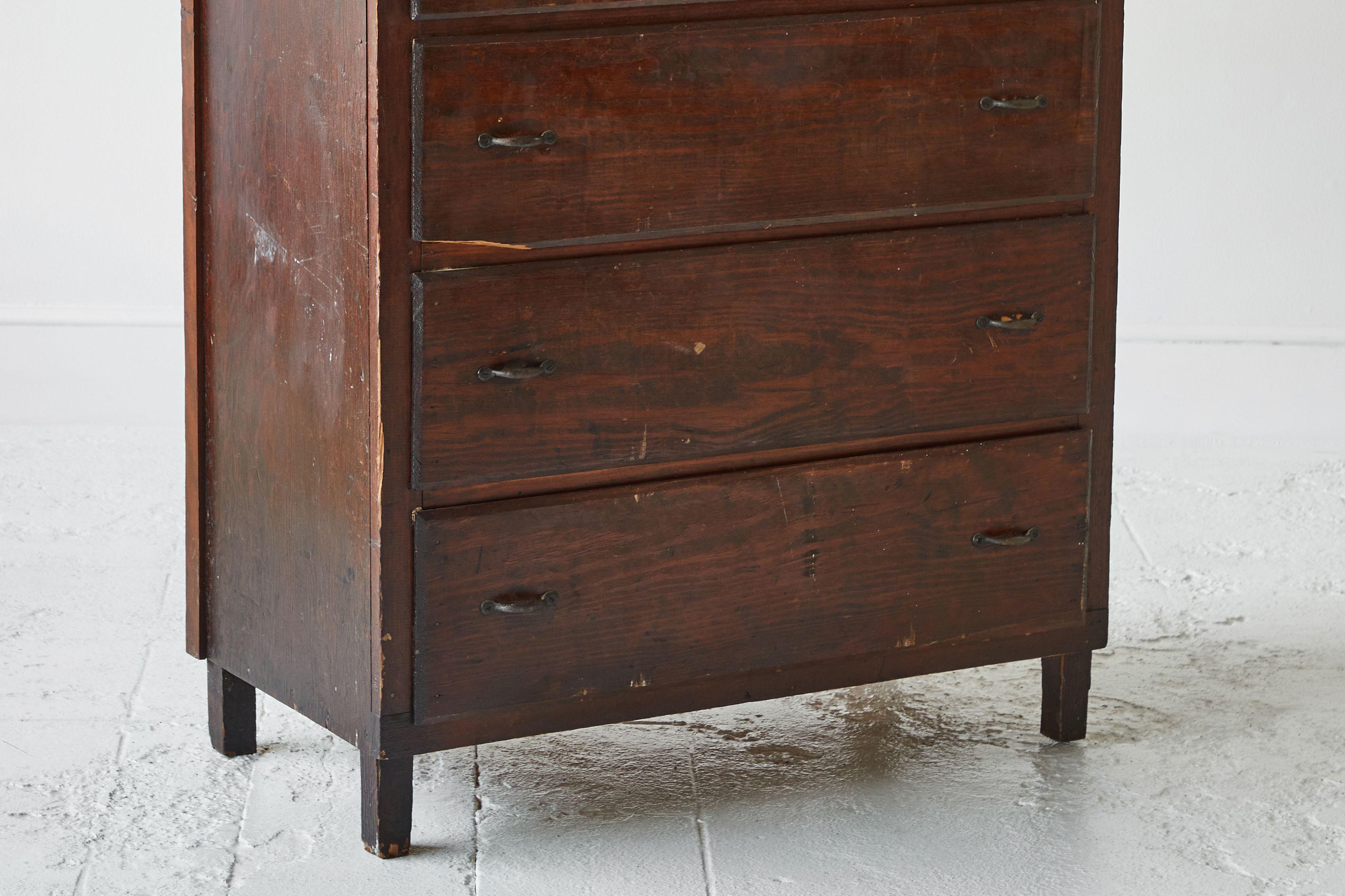 Early American rustic tall chest of drawer, natural stain with a crown top and original hardware.